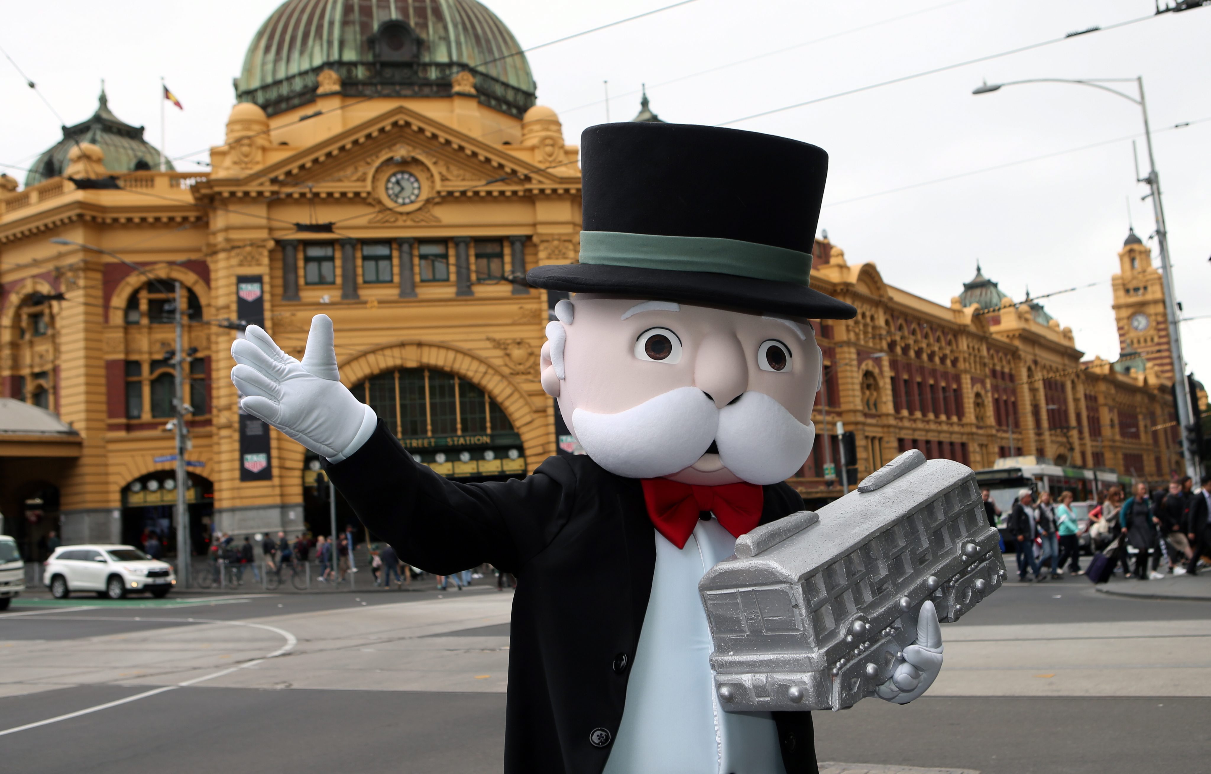 2015-11-10 10:23:19 epa05018717 Mr Monopoly unveils a version of Melbourne Monopoly in Federation Square in Melbourne, Australia, 10 November 2015. Over twenty Melbourne locations feature on the board, which players can move around using an open book, Sherrin football, spray can, racehorse, coffee cup or a W-class tram. EPA/DAVID CROSLING AUSTRALIA AND NEW ZEALAND OUT