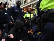 2017-01-20 08:47:14 epa05734768 Police step over demonstrators who block one of the entrances to the route of the inauguration parade at 10th Street near Pennsylvania Avenue to protest Donald J. Trump who will take the oath of office as he is sworn in as the 45th President of the United States in Washington, DC, USA, 20 January 2017. Trump won the 08 November 2016 election to become the next US President. EPA/Astrid Riecken EPA/Astrid Riecken