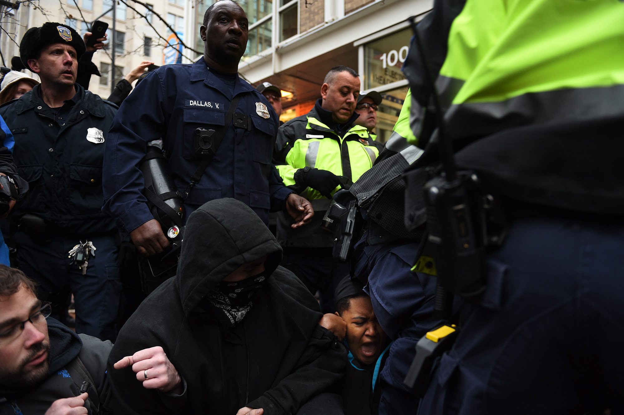 2017-01-20 08:47:14 epa05734768 Police step over demonstrators who block one of the entrances to the route of the inauguration parade at 10th Street near Pennsylvania Avenue to protest Donald J. Trump who will take the oath of office as he is sworn in as the 45th President of the United States in Washington, DC, USA, 20 January 2017. Trump won the 08 November 2016 election to become the next US President. EPA/Astrid Riecken EPA/Astrid Riecken