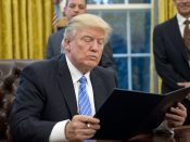 2017-01-23 11:46:33 epa05744780 US President Donald J. Trump reads the first of three Executive Orders he will sign in the Oval Office of the White House in Washington, DC, USA, 23 January 2017. They concerned the withdrawal of the United States from the Trans-Pacific Partnership (TPP), a US Government hiring freeze for all departments but the military, and "Mexico City" which bans federal funding of abortions overseas. EPA/Ron Sachs / POOL