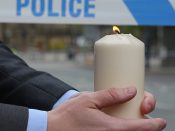 2017-05-23 05:04:36 epa05982975 A person holds a lit candle during a prayer session with the Dean of Manchester near the Manchester Arena in Manchester, Britain, 23 May 2017. According to a statement by the Greater Manchester Police, at least 22 people have been confirmed dead and around 59 others were injured, in an explosion at the Manchester Arena on the night of 22 May at the end of a concert by US singer Ariana Grande. Police believe that the explosion, which is being treated as a terrorist incident, was carried out by a single man using an improvised explosive device (IED), who was confirmed dead at the scene. EPA/NIGEL RODDIS