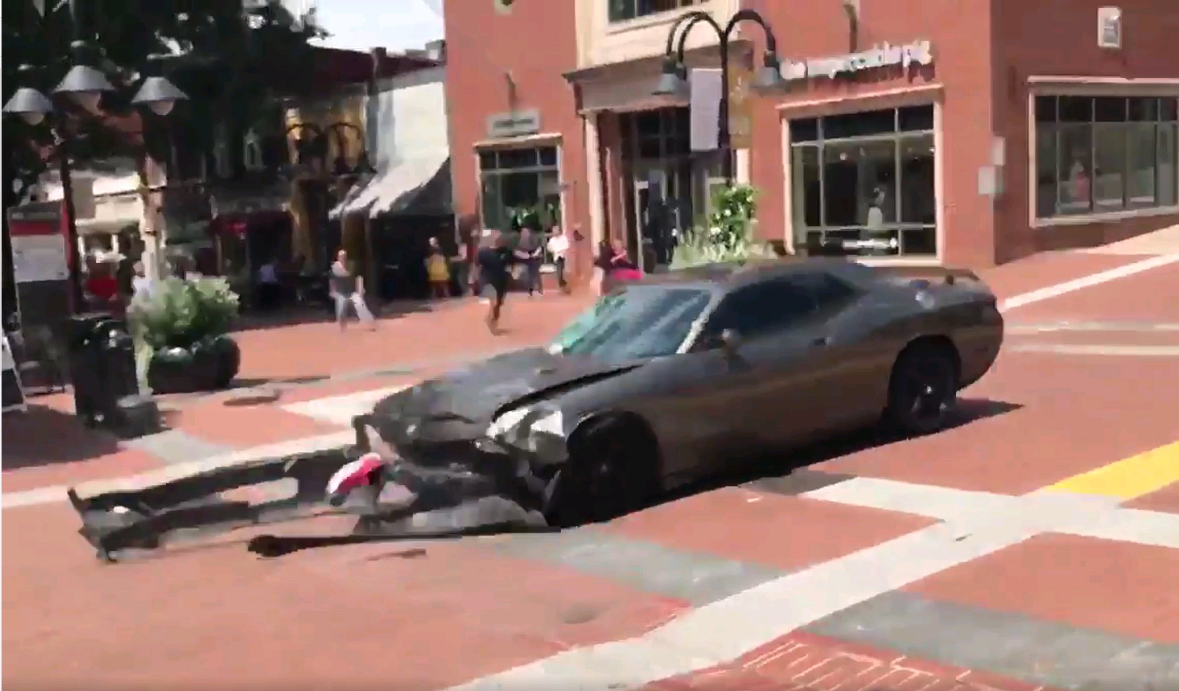 2017-08-12 00:00:00 epa06140860 A video grab made available by Brennan Gilmore? shows a car reversing after hitting a crowd in Charlottesville, Virginia, USA, 12 August 2017. According to media reports at least one person was killed after a car hit a crowd of people counter-protesting the 'Unite the Right' rally which was scheduled to take place in Charlottesville on 12 August. EPA/BRENNAN GILMORE / HANDOUT HANDOUT EDITORIAL USE ONLY/NO SALES