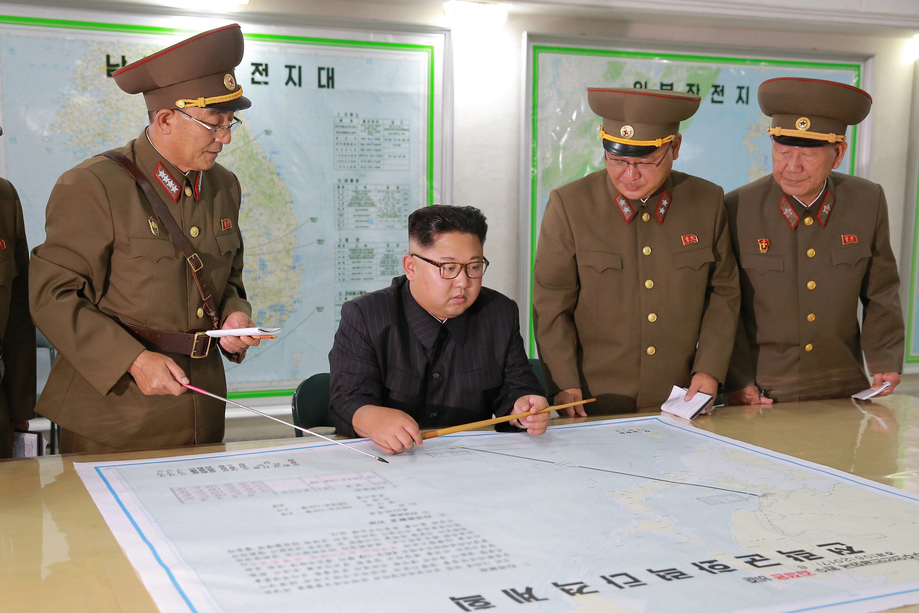 2017-08-14 00:00:00 epa06145192 A picture released by the North Korean Central News Agency (KCNA) North Korean leader Kim Jong Un inspecting plans to fire missiles towards the US Pacific territory of Guam at the Command of the Strategic Force of the Korean People's Army (KPA), Pyongyang, DPRK: North Korean 14 August 2017, (issued 15 August 2017). According to North Korean state media on 09 August 2017, the North is considering a potential pre-emptive strike with medium-to-long-range strategic ballistic missiles on Guam, where US tactical bombers are based. The threat follows US President Donald J. Trump's warning to Pyongyang that any threat to the USA 'will be met with fire and fury like the world has never seen.' The exchanges marked rising tensions between the two countries. EPA/KCNA