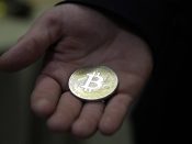 2017-08-29 19:07:55 epa06170774 A visitor holds a Bitcoin (virtual currency) souvenir coin, during a webinar by Russian businessman, Orthodox activist and founder the Crypto exchange CryptoSterlingClub Alisa, German Sterligov at the main office of CryptoSterlingClub Alisa in Moscow, Russia, 29 August 2017. According to media reports, Russian Finance Ministry stated that cryptocurrencies like bitcoin are a high risky 'financial pyramid' and trading should be limited to only 'qualified investors'. The CryptoSterlingClub Alisa was opened on 24 August 2017. EPA/MAXIM SHIPENKOV