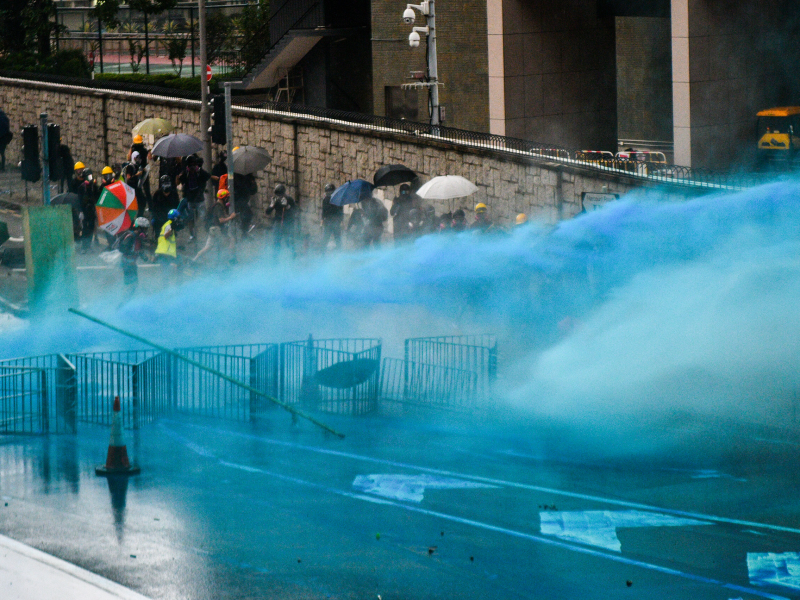 Hong Kong police are spraying protesters with blue-dye water cannons to ...