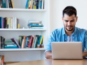 Mexican hipster man working with computer indoor at desk at home
