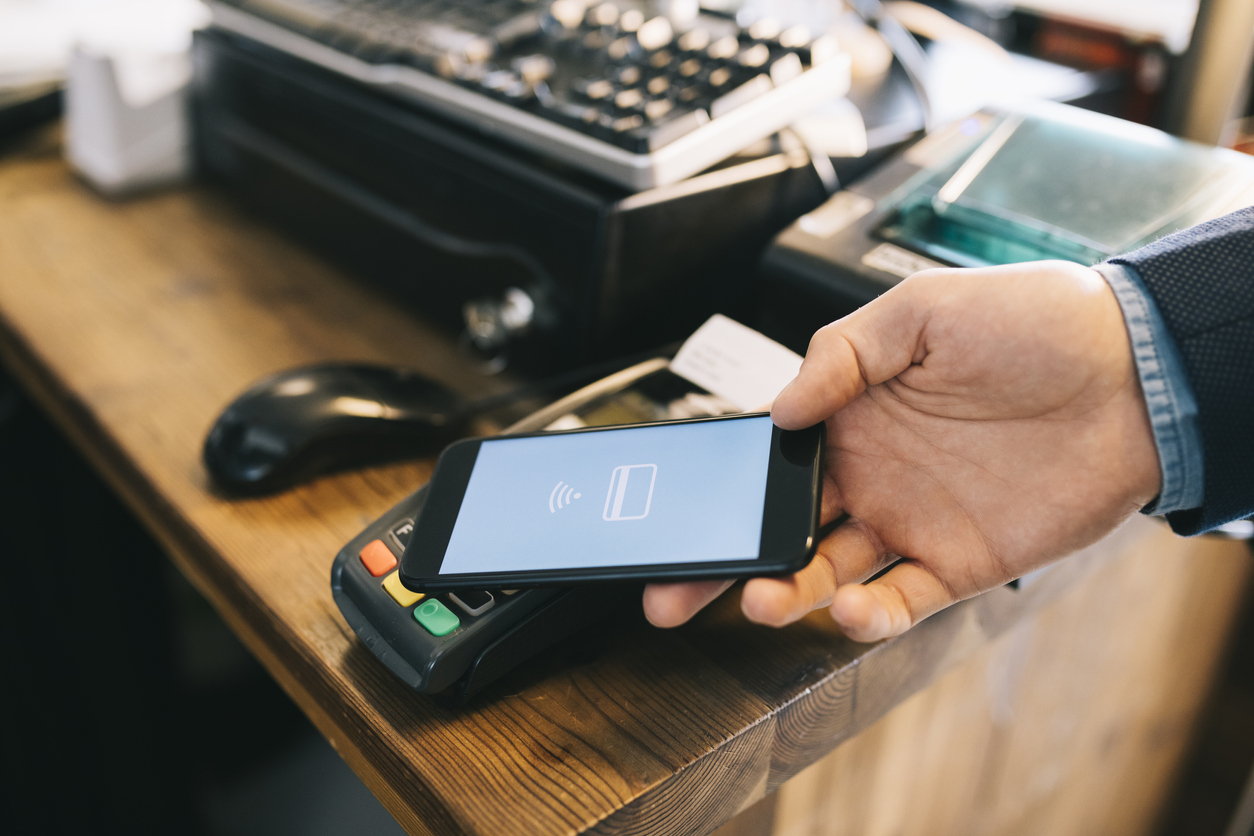 Man paying with smartphone using NFC.