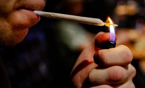Bezoeker van een coffeeshop steekt een joint op. Foto ter illustratie: ANP/Robin van Lonkhuijsen Bezoeker van een coffeeshop steekt een joint op. Foto ter illustratie: ANP/Robin van Lonkhuijsen