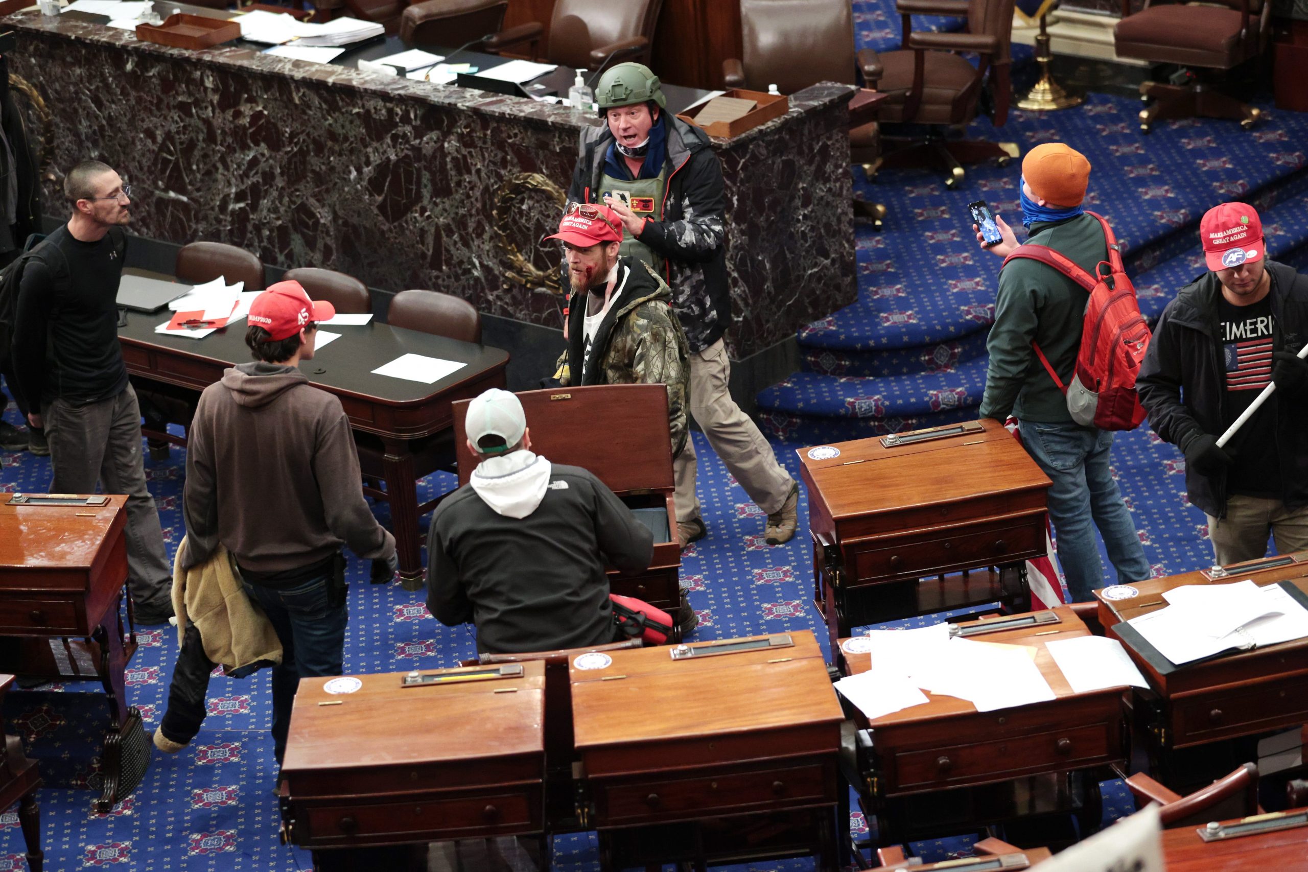 Protesters, including Larry Brock in back, enter the Senate Chamber on January 06, 2021 in Washington, DC. Congress held a joint session today to ratify President-elect Joe Biden's 306-232 Electoral College win over President Donald Trump. Pro-Trump protesters have entered the U.S. Capitol building after mass demonstrations in the nation's capital.