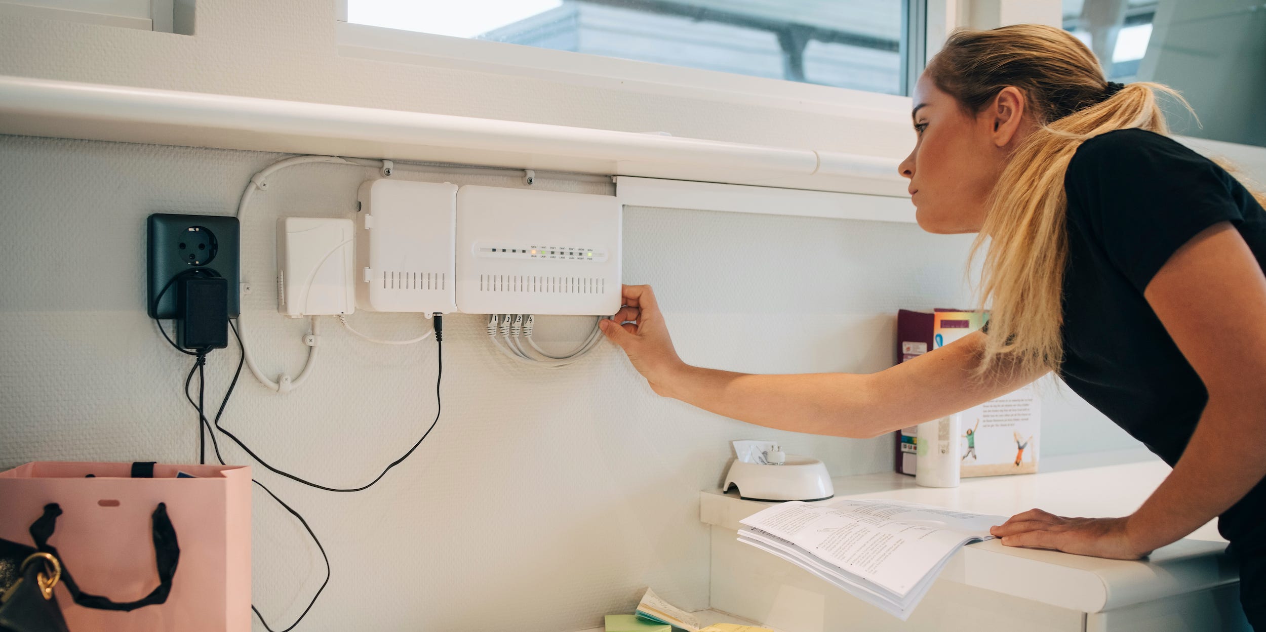 woman checking wifi signal on internet router