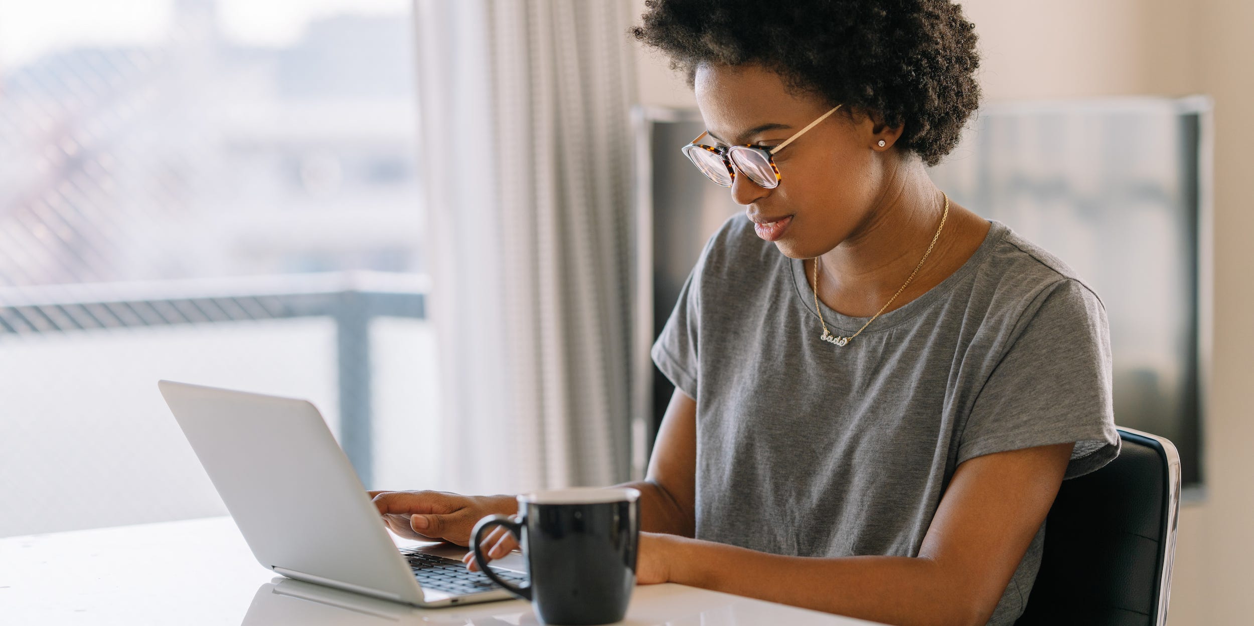 young professional using laptop at home typing