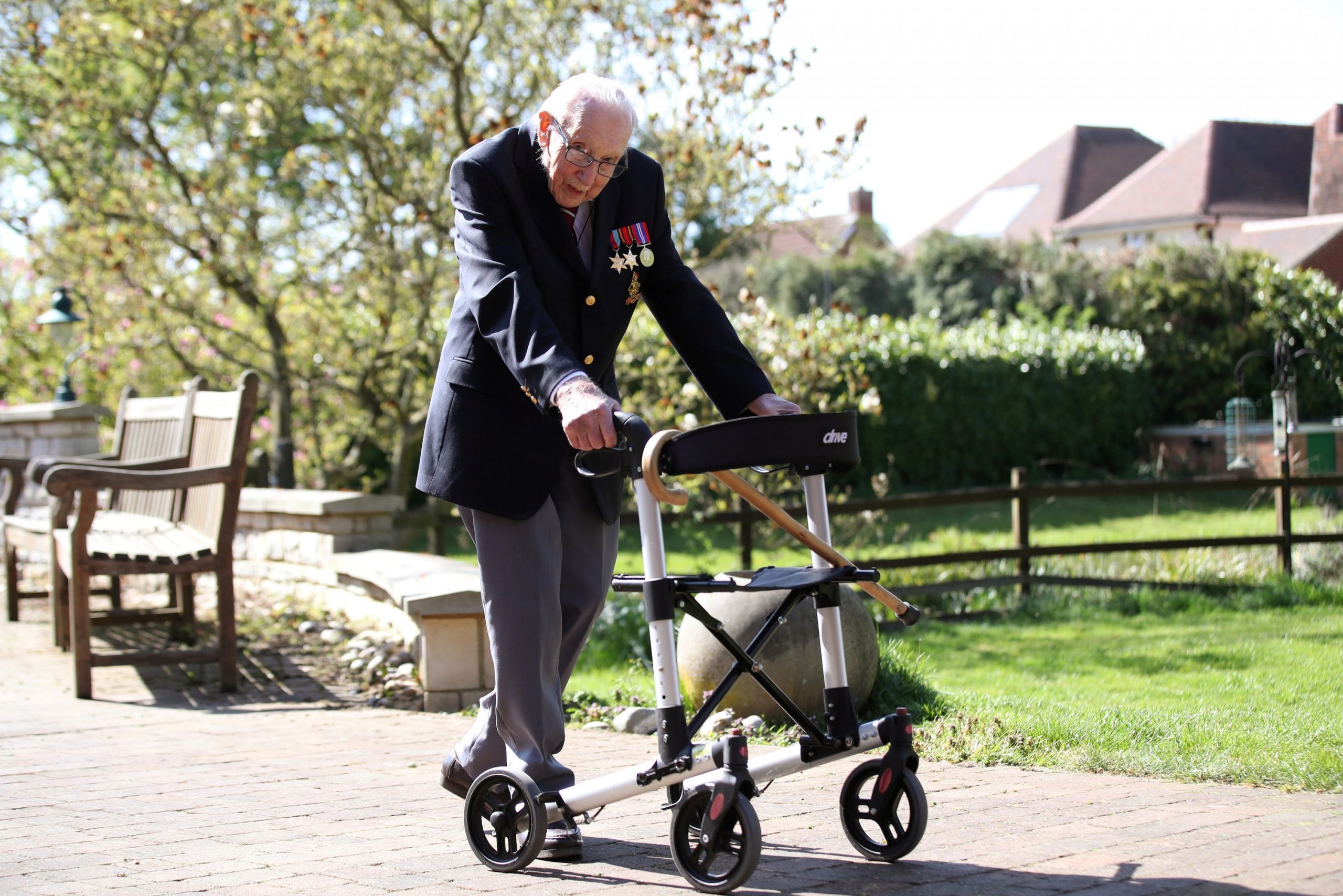 Retired British Army Captain Tom Moore, 99, walks to raise money for health workers, by attempting to walk the length of his garden one hundred times before his 100th birthday this month as the spread of coronavirus disease (COVID-19) continues, Marston Moretaine, Britain, April 15, 2020.