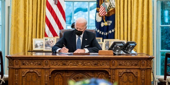 President Joe Biden signing documents
