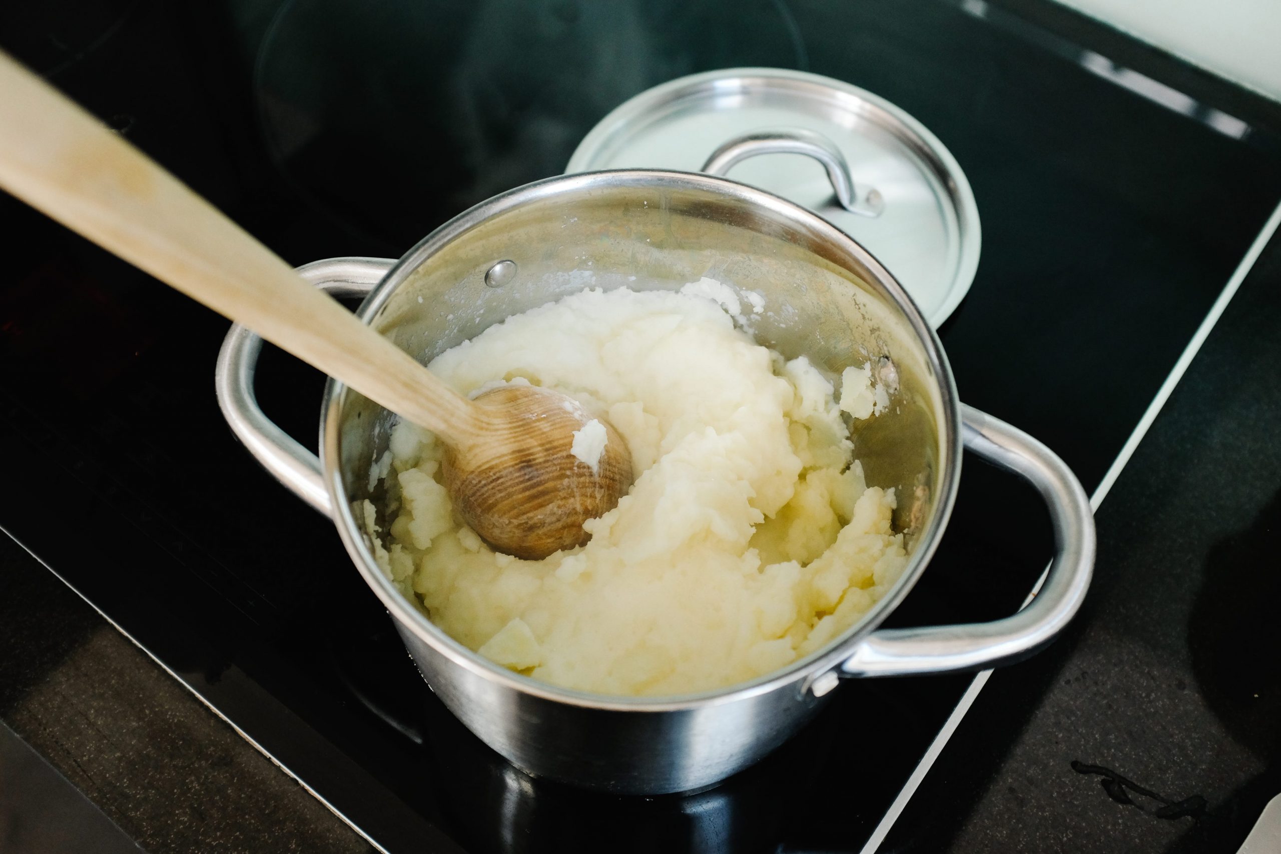 making mashed potatoes pot stove spoon