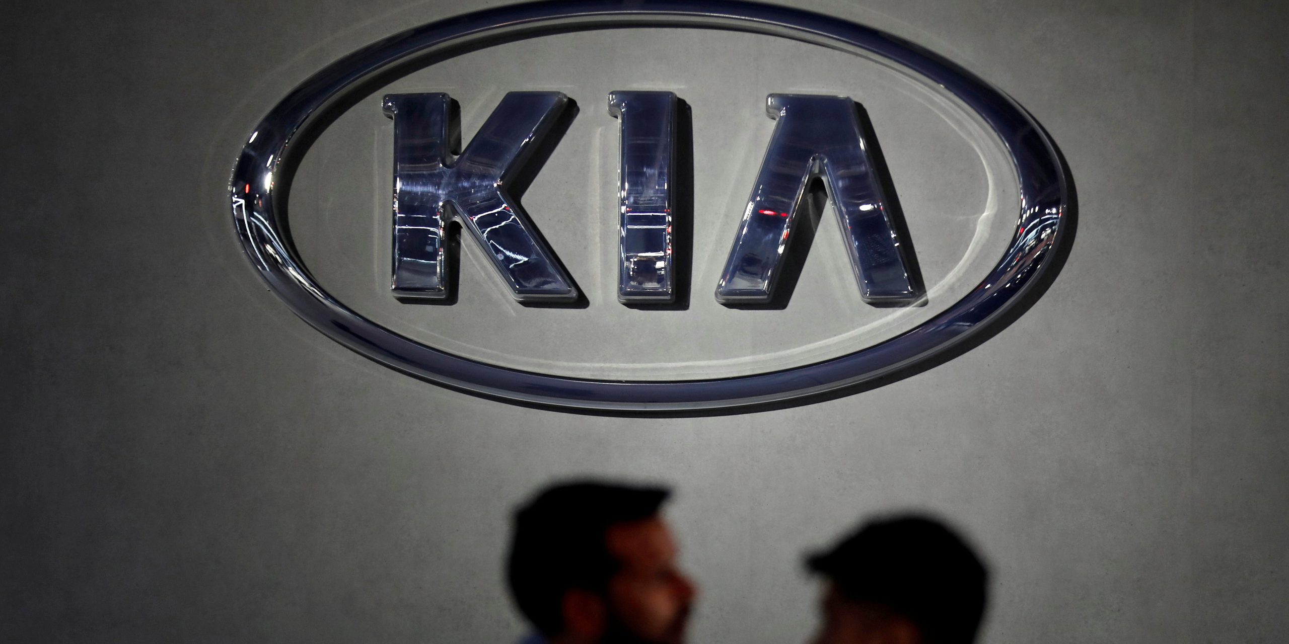 FILE PHOTO: Visitors walk past the logo of Kia Motors at its pavilion at the India Auto Expo 2020 in Greater Noida, India, February 5, 2020. REUTERS/Anushree Fadnavis