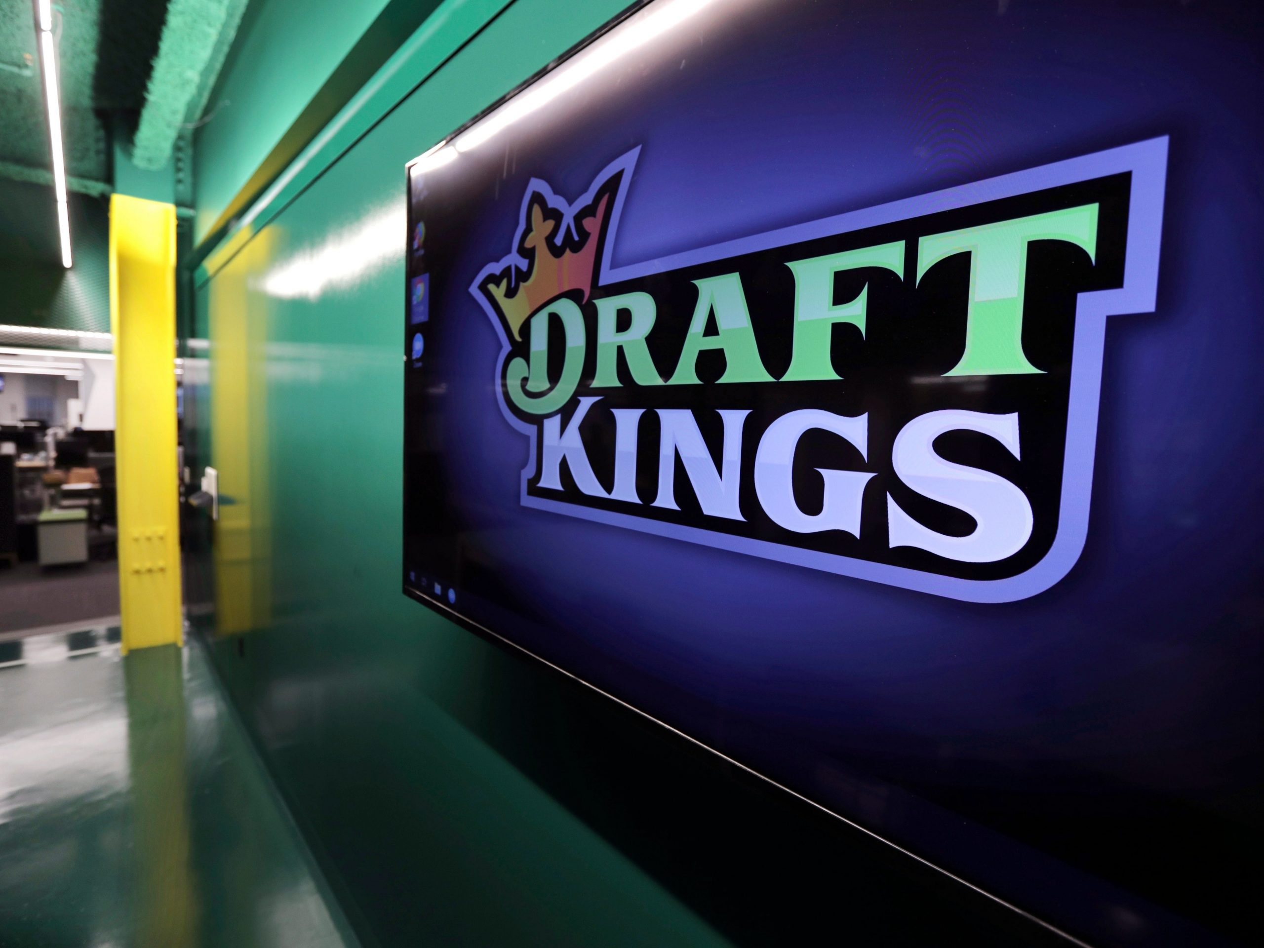 FILE - In this May 2, 2019, file photo, the DraftKings logo is displayed at the sports betting company headquarters in Boston. Sports daily fantasy and betting website DraftKings will debut as a publicly traded company Friday, April 24, 2020, against a backdrop of a near-complete shutdown of athletic competition across the globe due to the coronavirus pandemic. (AP Photo/Charles Krupa, File)