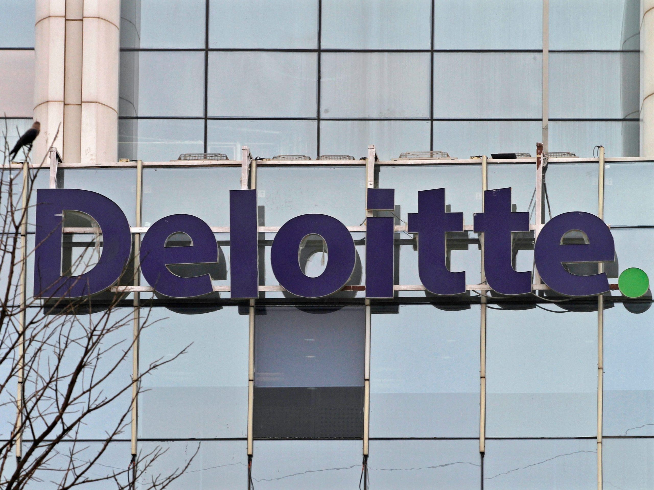 FILE PHOTO: The Deloitte Company logo is seen on a commercial tower at Gurgaon, on the outskirts of New Delhi August 9, 2012. The Big Four accounting and consulting firms, Deloitte, Ernst & Young, KPMG and PwC, also are offshoring some audit work for U.S. companies to India, where salaries for accountants are a fraction of those in the United States. REUTERS/Parivartan Sharma 