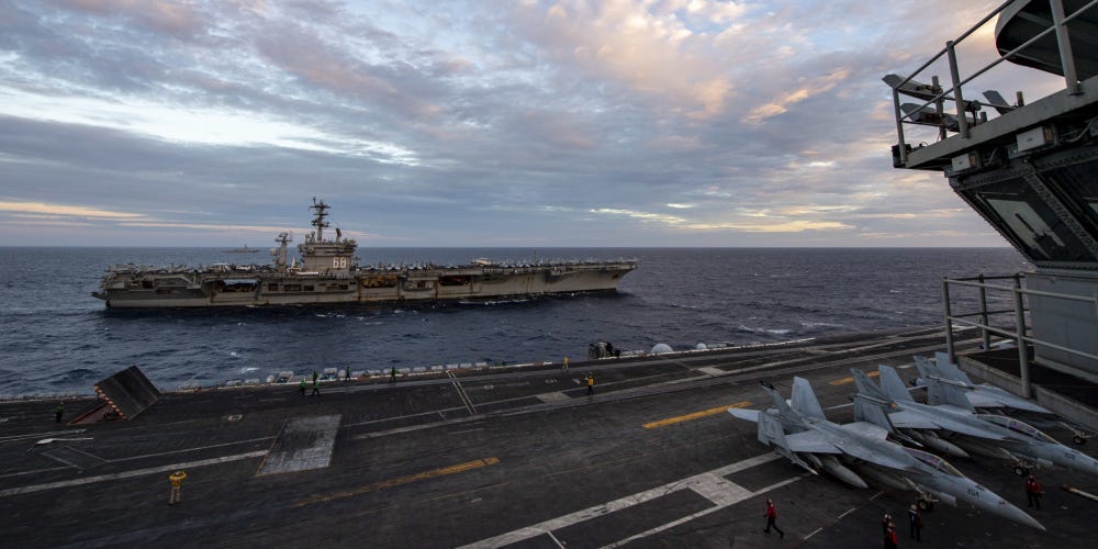 The Theodore Roosevelt Carrier Strike Group transits in formation with the Nimitz Carrier Strike Group in the South China Sea Feb. 9, 2021