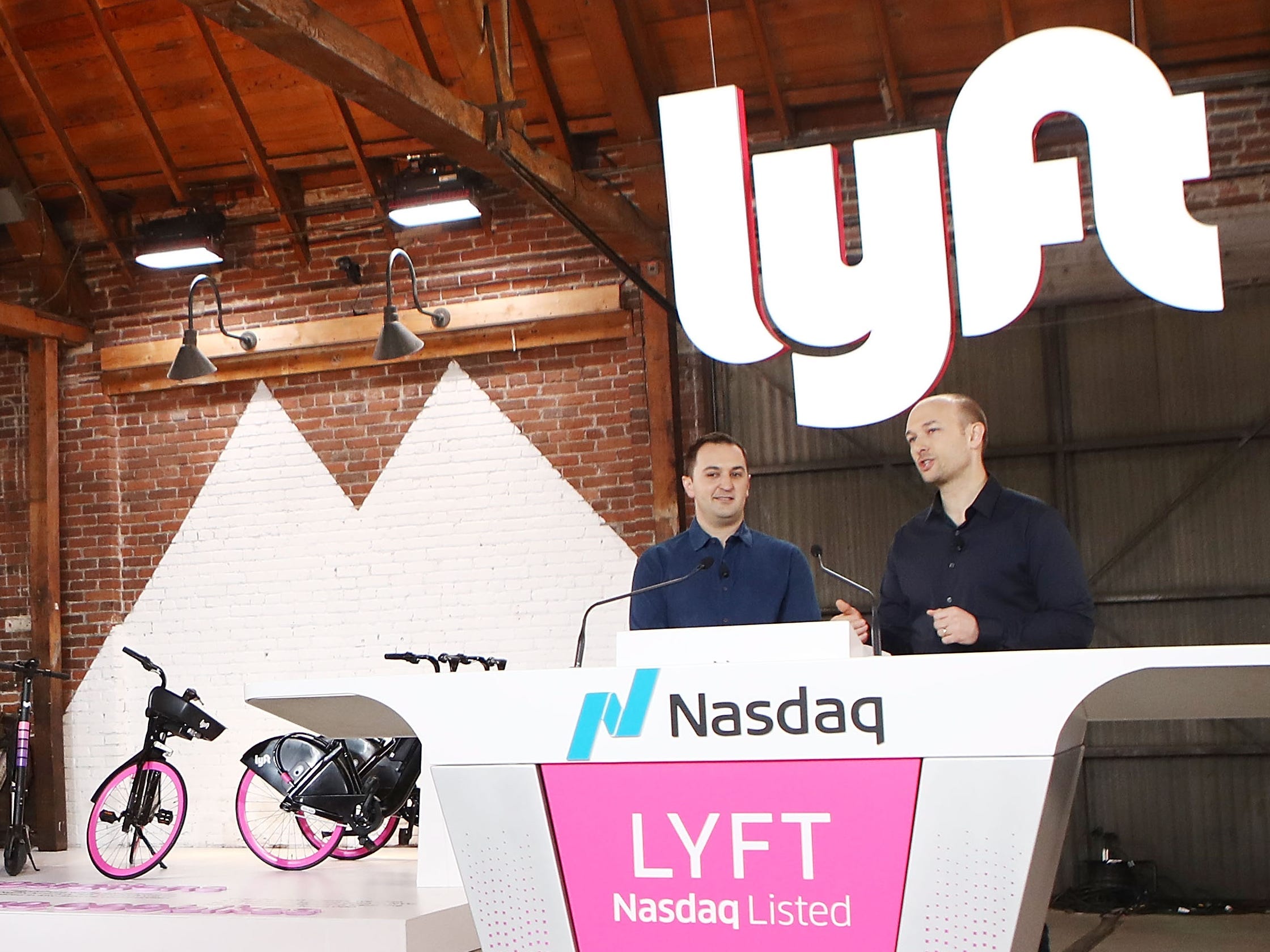GettyImages 1133503729 LOS ANGELES, CA - MARCH 29: Lyft CEO Logan Green (R) and President John Zimmer (2nd R) speak before the Nasdaq opening bell celebrating the company's initial public offering (IPO) on March 29, 2019 in Los Angeles, California. The ride hailing app company's shares were initially priced at $72. (Photo by Mario Tama/Getty Images)
