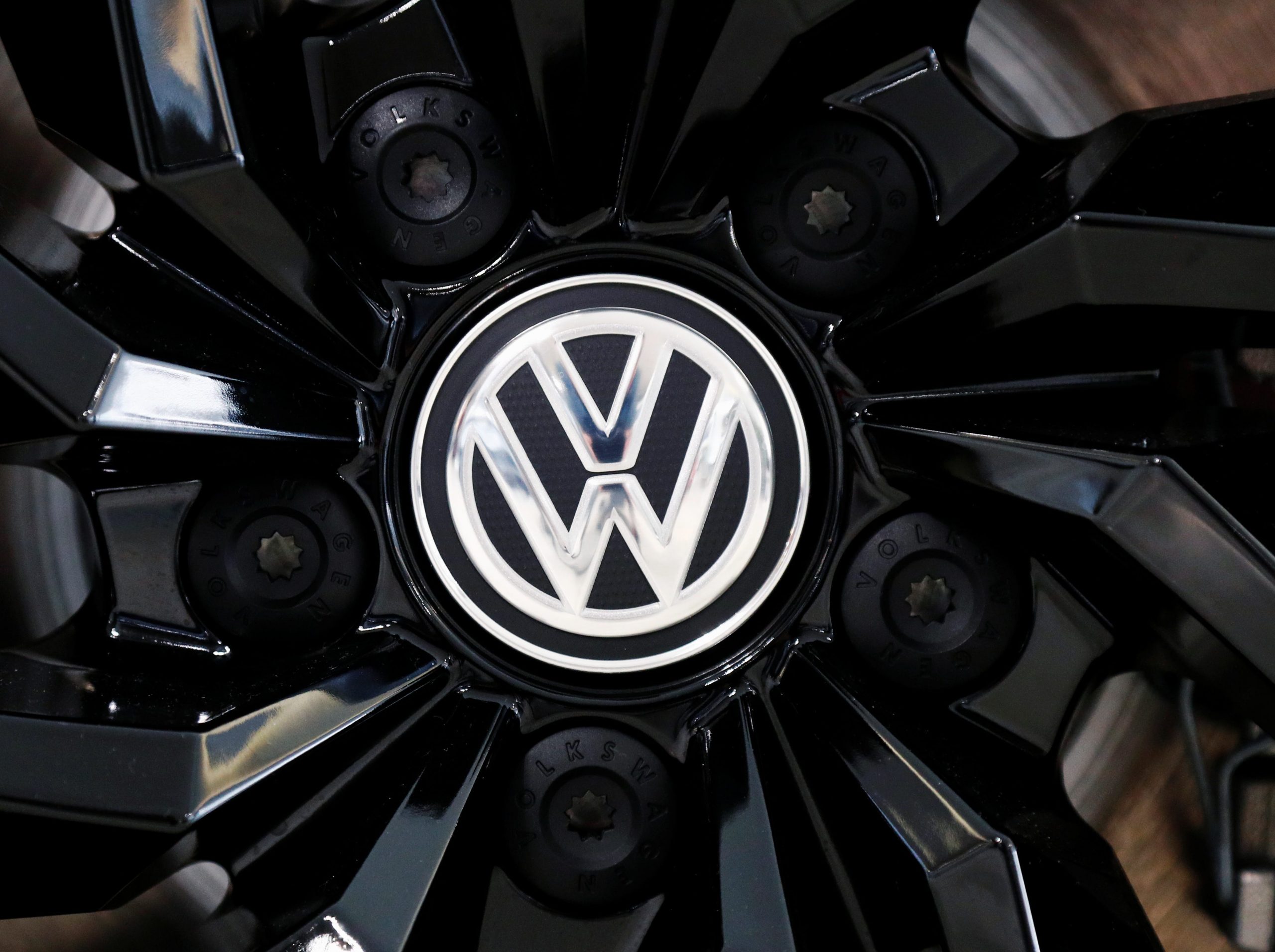 FILE PHOTO: The logo of German carmaker Volkswagen is seen on a rim cap in a showroom of a Volkswagen car dealer in Brussels, Belgium July 9, 2020. REUTERS/Francois Lenoir