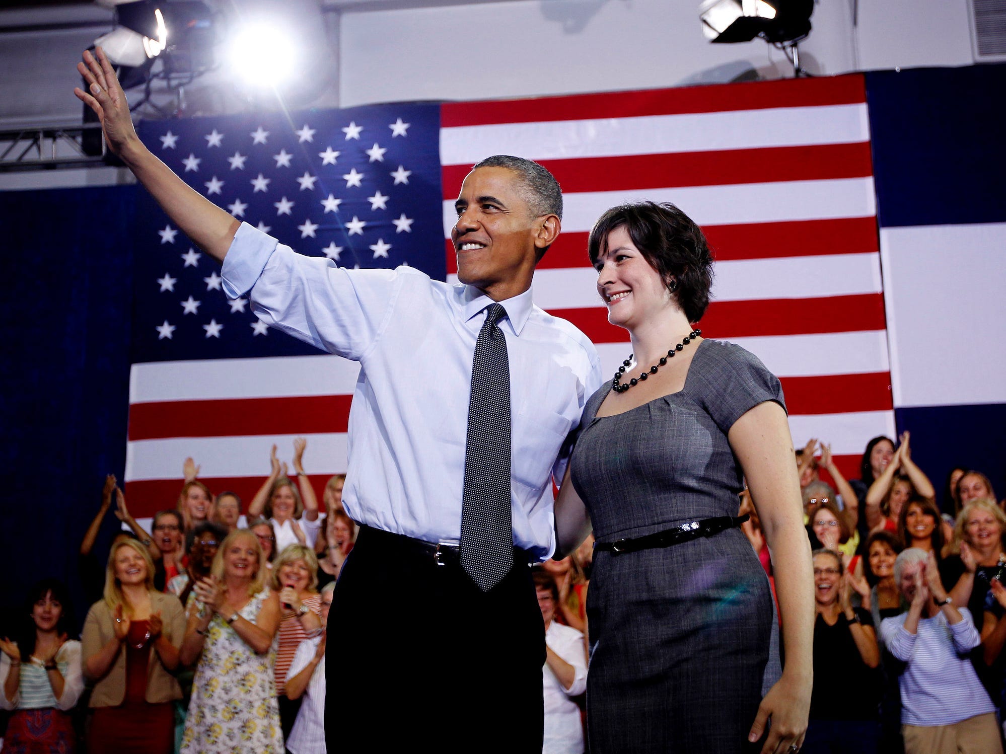 President Barack Obama, accompanied by Sandra Fluke, waves at a campaign event at the University of Colorado Auraria Events Center, Wednesday, Aug. 8, 2012,