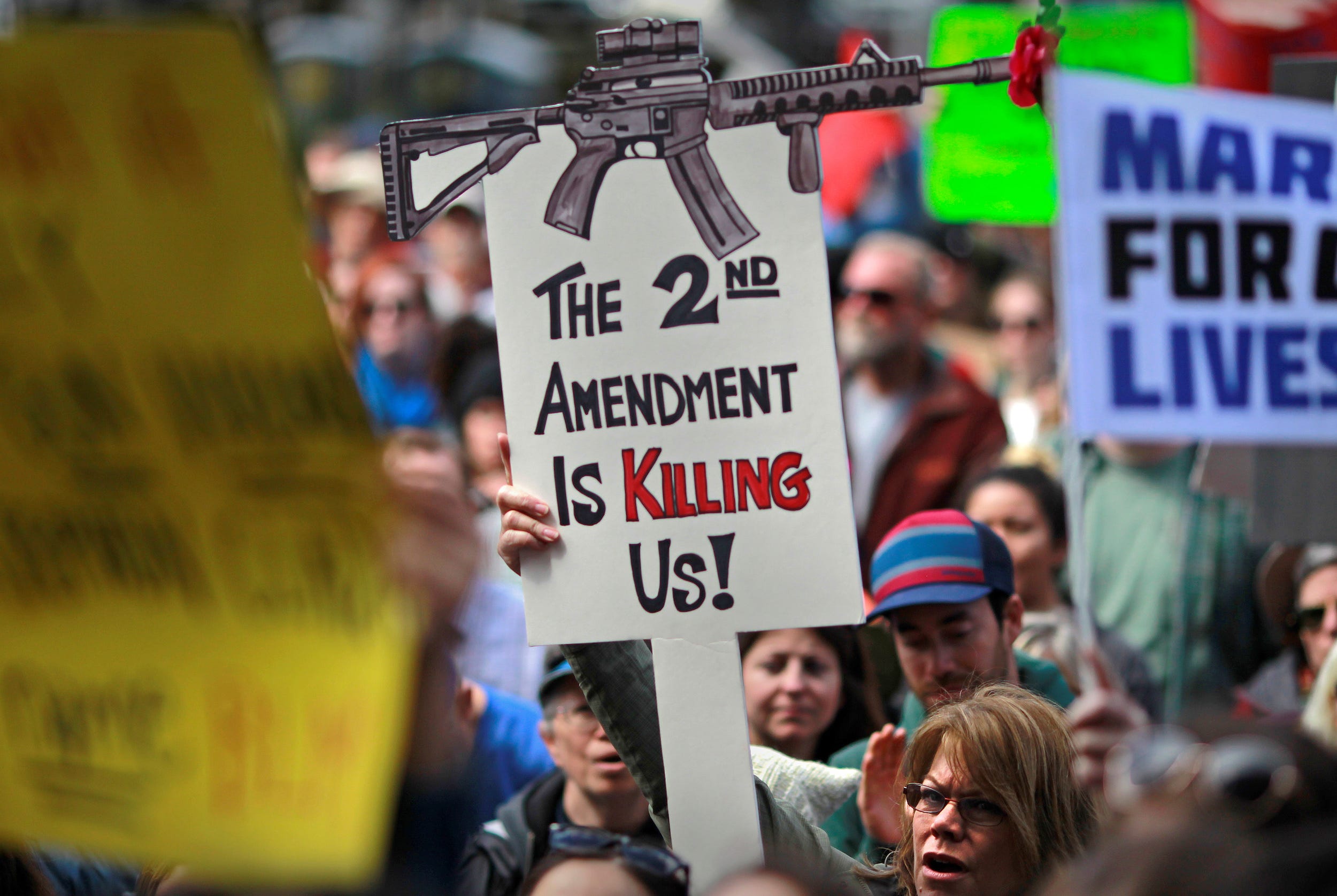 Protestors hold signs during a "March For Our Lives" demonstration demanding gun control in Sacramento, California, U.S. March 24, 2018.