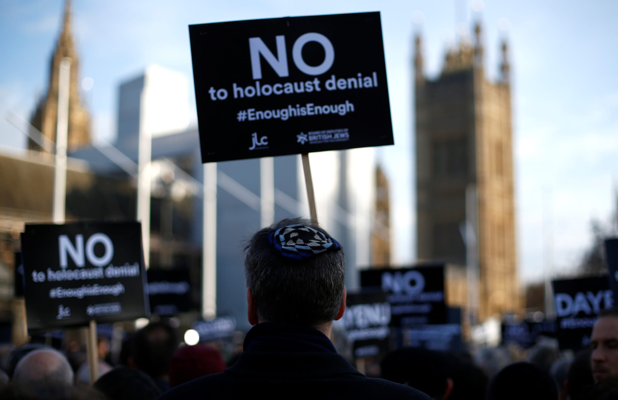 Protesters hold placards and flags during a demonstration, organised by the British Board of Jewish Deputies for those who oppose anti-Semitism, in Parliament Square in London, Britain, March 26, 2018.