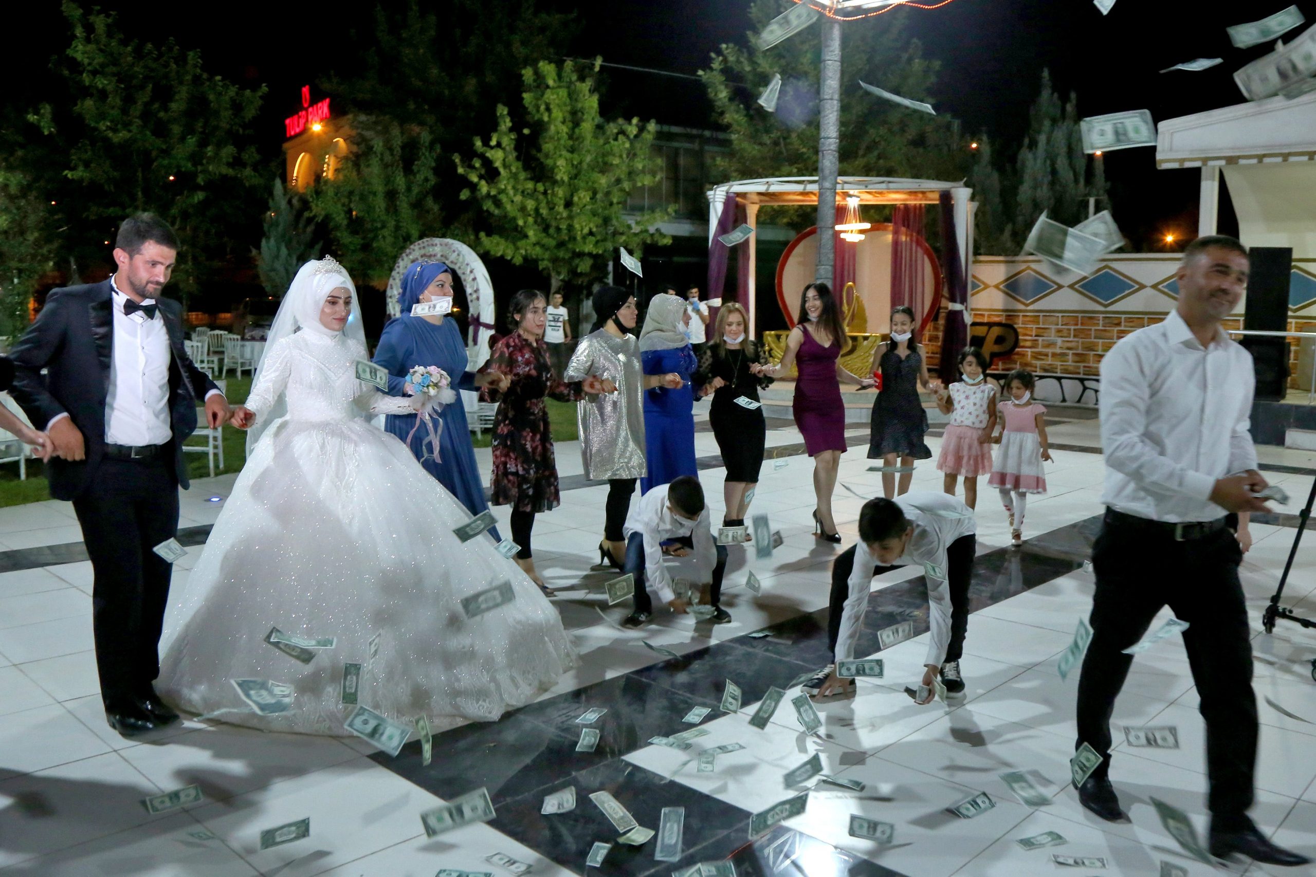 Groom Serdal Aman and bride Filiz Peker dance with their relatives during their wedding after Turkey lifted restrictions on the ceremonies which had been imposed to prevent the spread of the coronavirus disease (COVID-19), in Diyarbakir, Turkey, July 1, 2020. REUTERS/Sertac Kayar