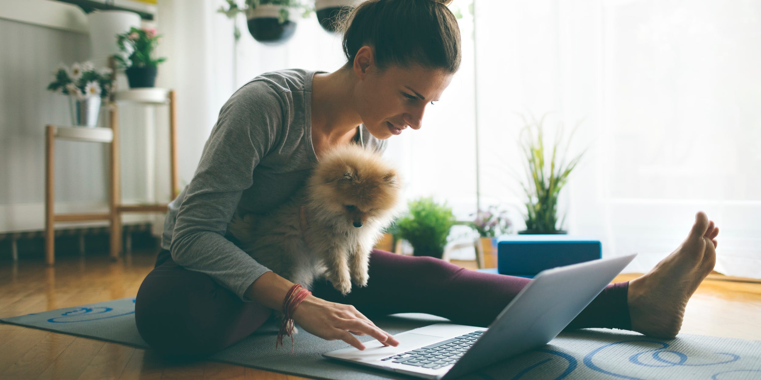 working out from home on laptop yoga mat