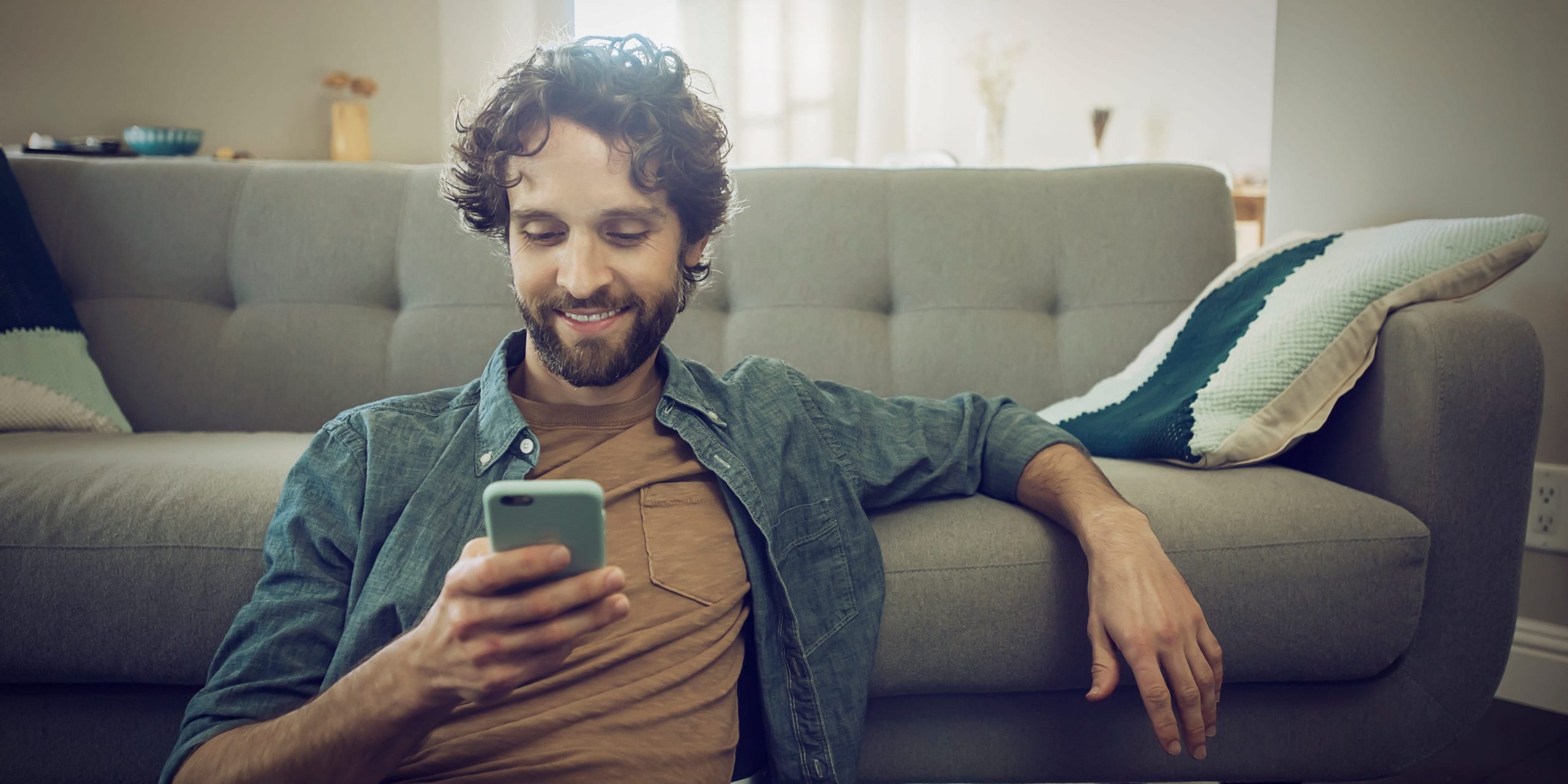man checks smartphone