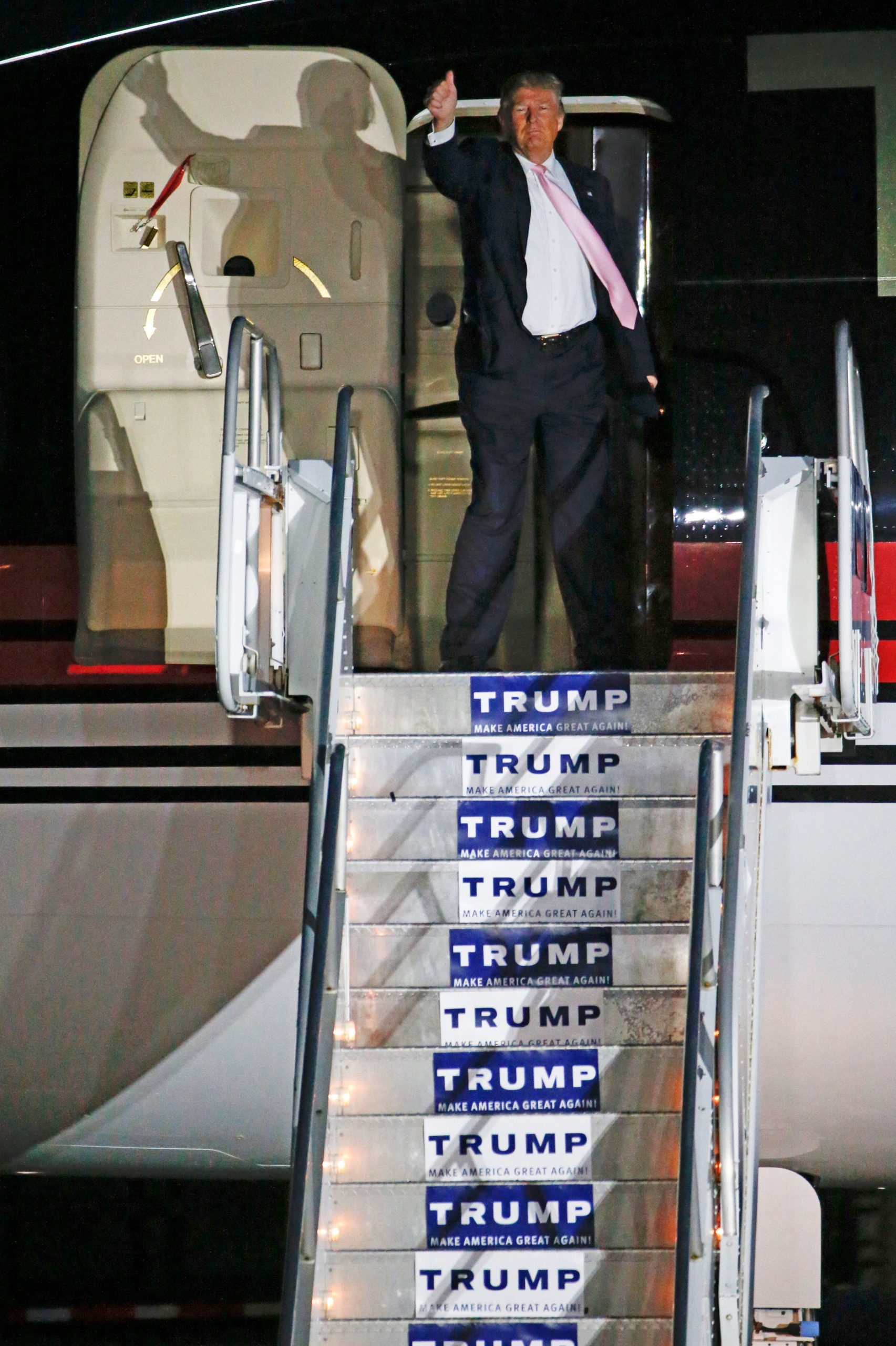 Candidate Donald Trump giving a thumbs up in front of his 757 in 2016