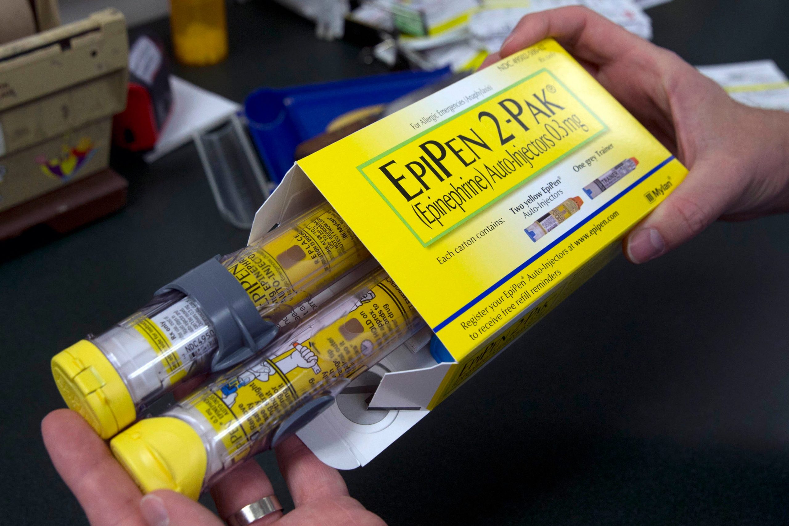 FILE - In this July 8, 2016, file photo, a pharmacist holds a package of EpiPens epinephrine auto-injector, a Mylan product, in Sacramento, Calif. On Tuesday, March 24, 2020, the U.S. Food and Drug Administration warned the public about malfunctions involving some EpiPens, the emergency injectors for severe allergic reactions. (AP Photo/Rich Pedroncelli, File)