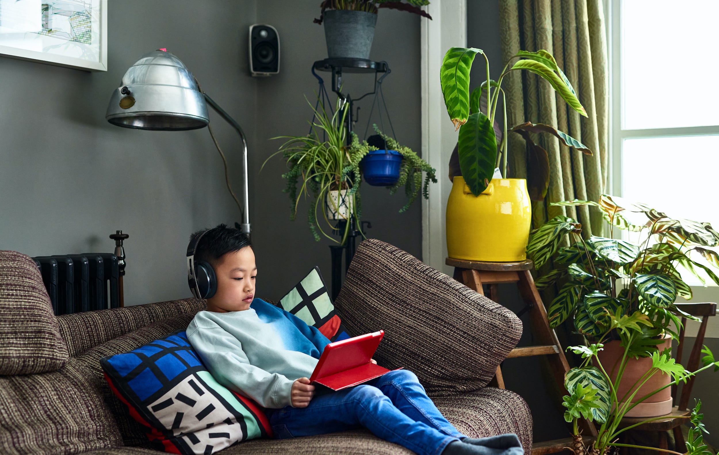 kid watching movie on ipad tablet at home