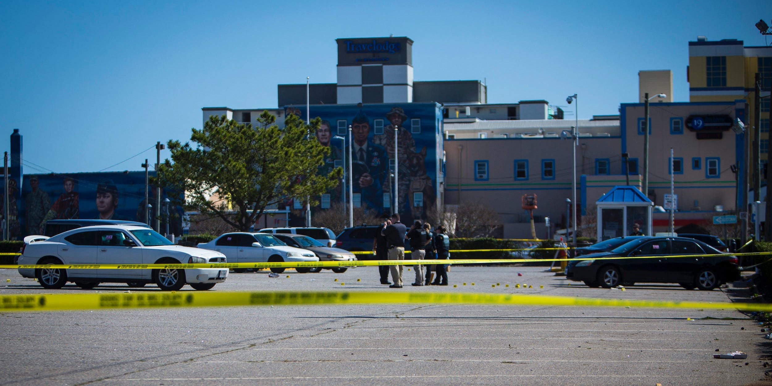 Virginia Beach police work the scene of a shooting the night before on Saturday, March 27, 2021 in Virginia Beach, Virginia.