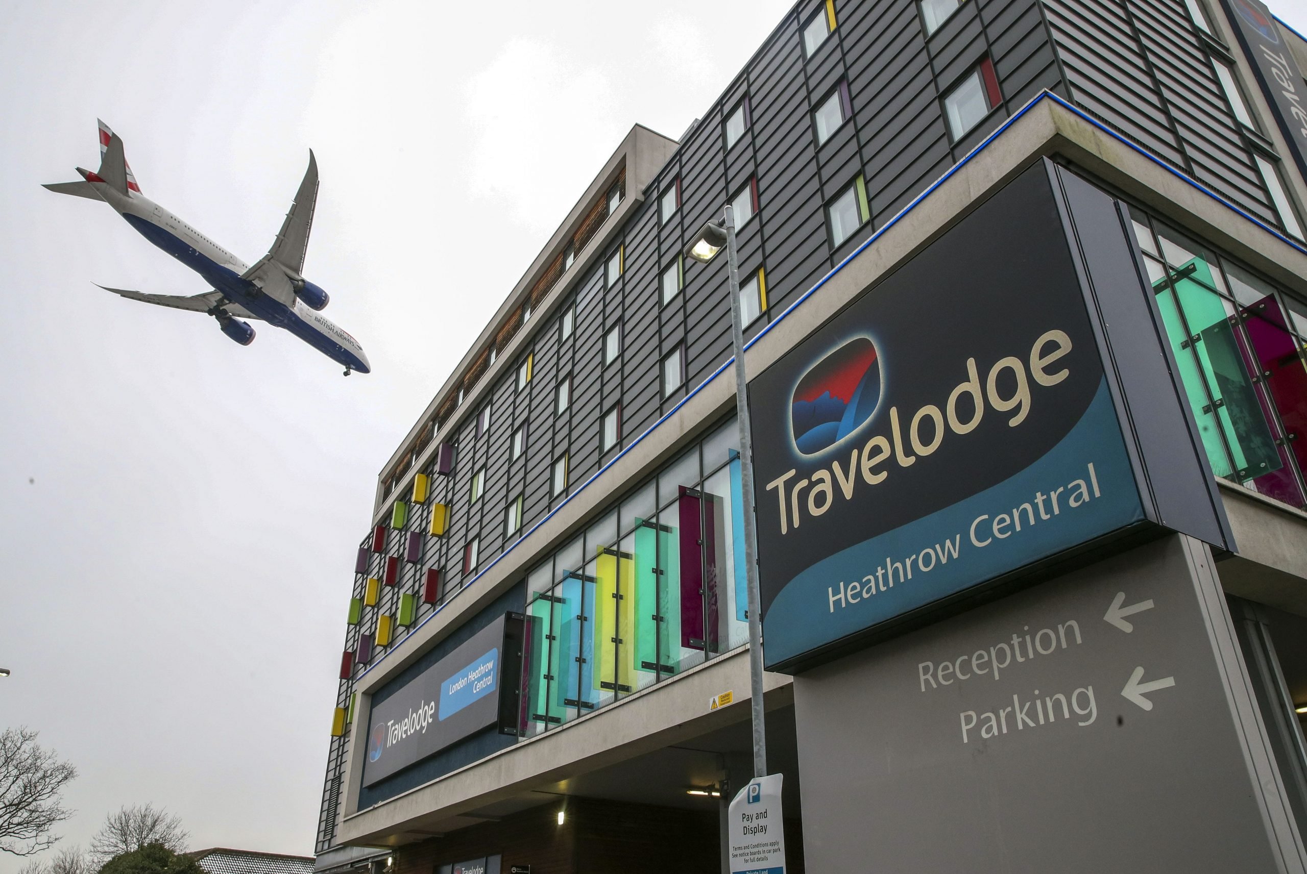 A plane passes over the Travelodge Hotel at Heathrow.