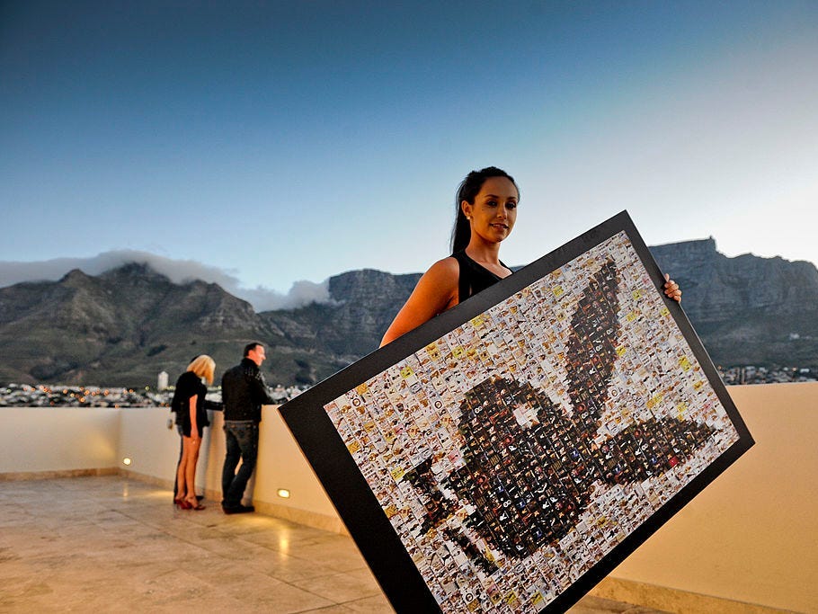 Former playboy model Esté Swanepoel holding an mosaic framed picture of the iconic bunny at the Playboy publishing gala event