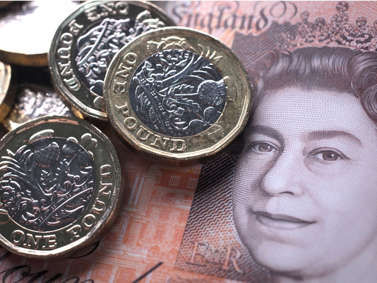 In this photo illustration, £1 coins are seen with the new £10 note on October 13, 2017 in Bath, England. Matt Cardy/Getty Images