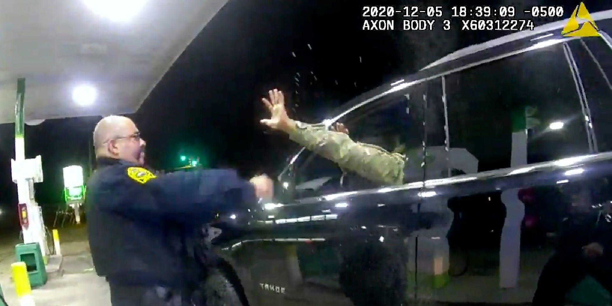 A police officer uses a spray agent on Caron Nazario on Dec. 20, 2020, in Windsor, Va.