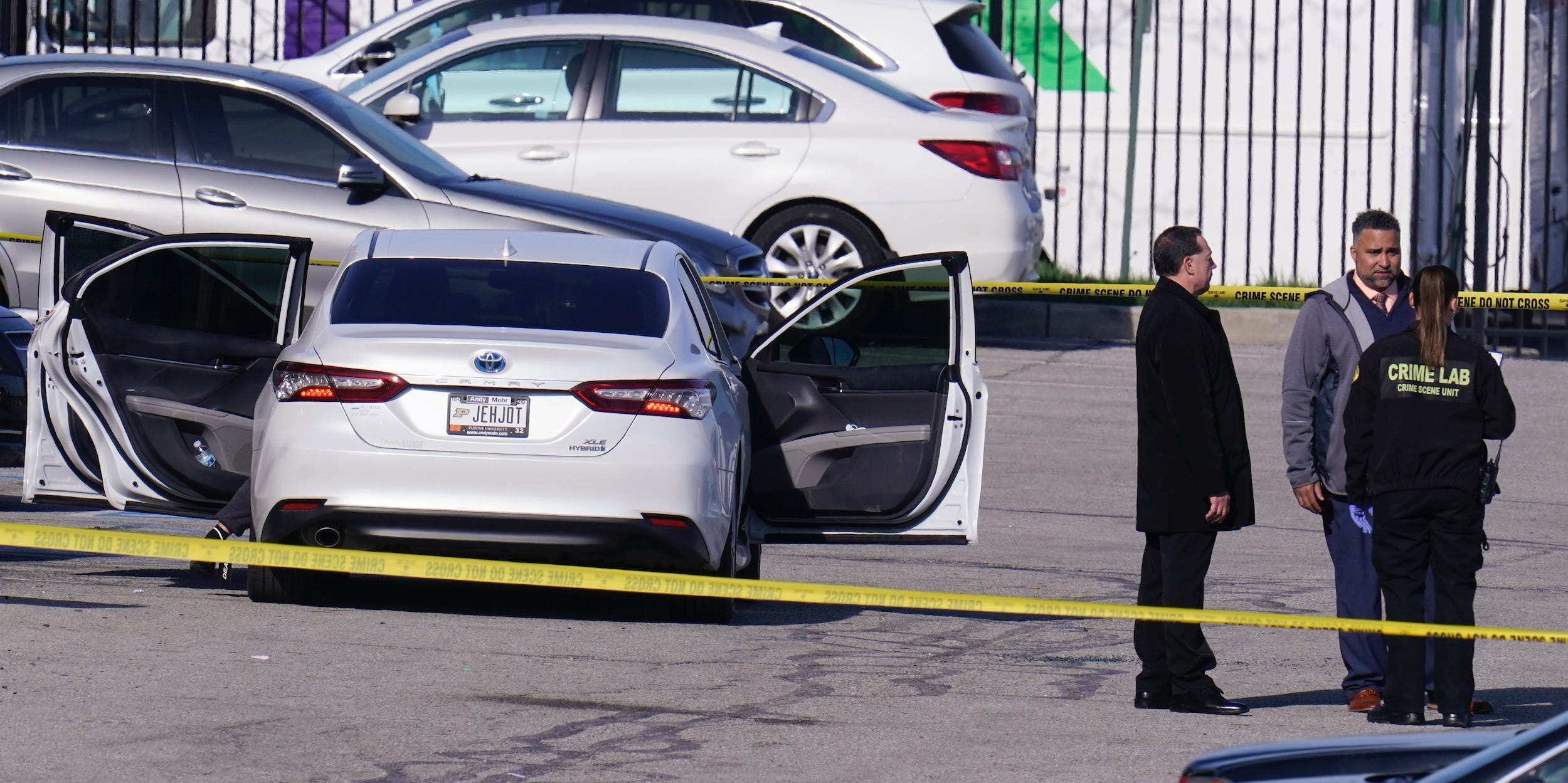 Authorities confer at the scene where multiple people were shot at the FedEx Ground facility early Friday morning, April 16, 2021, in Indianapolis. A gunman killed eight people and wounded several others before apparently taking his own life in a late-night attack at a FedEx facility near the Indianapolis airport, police said, in the latest in a spate of mass shootings in the United States after a relative lull during the pandemic. (AP Photo/Michael Conroy)