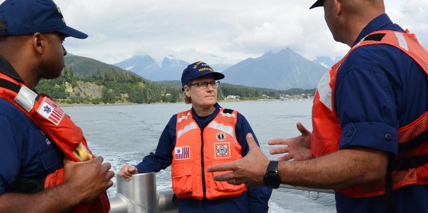 Vice Adm. Linda Fagan, Coast Guard Pacific Area commander, speaks with two Coast Guard officers while underway in Auke Bay, Alaska.