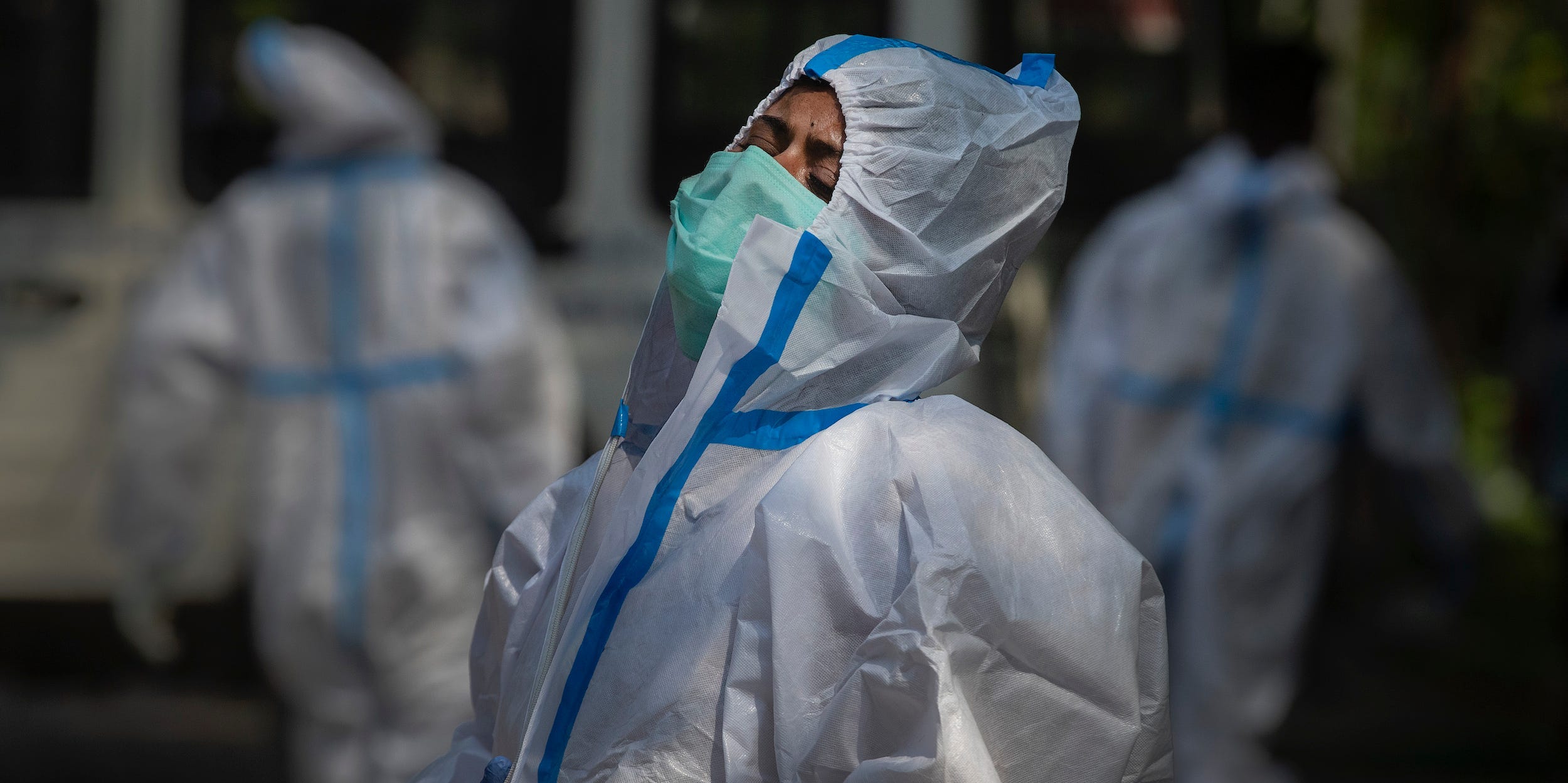 The fiancee of a person who died of COVID-19 breaks down during cremation in Gauhati, India, Tuesday, April 27, 2021. Coronavirus cases in India are surging faster than anywhere else in the world.