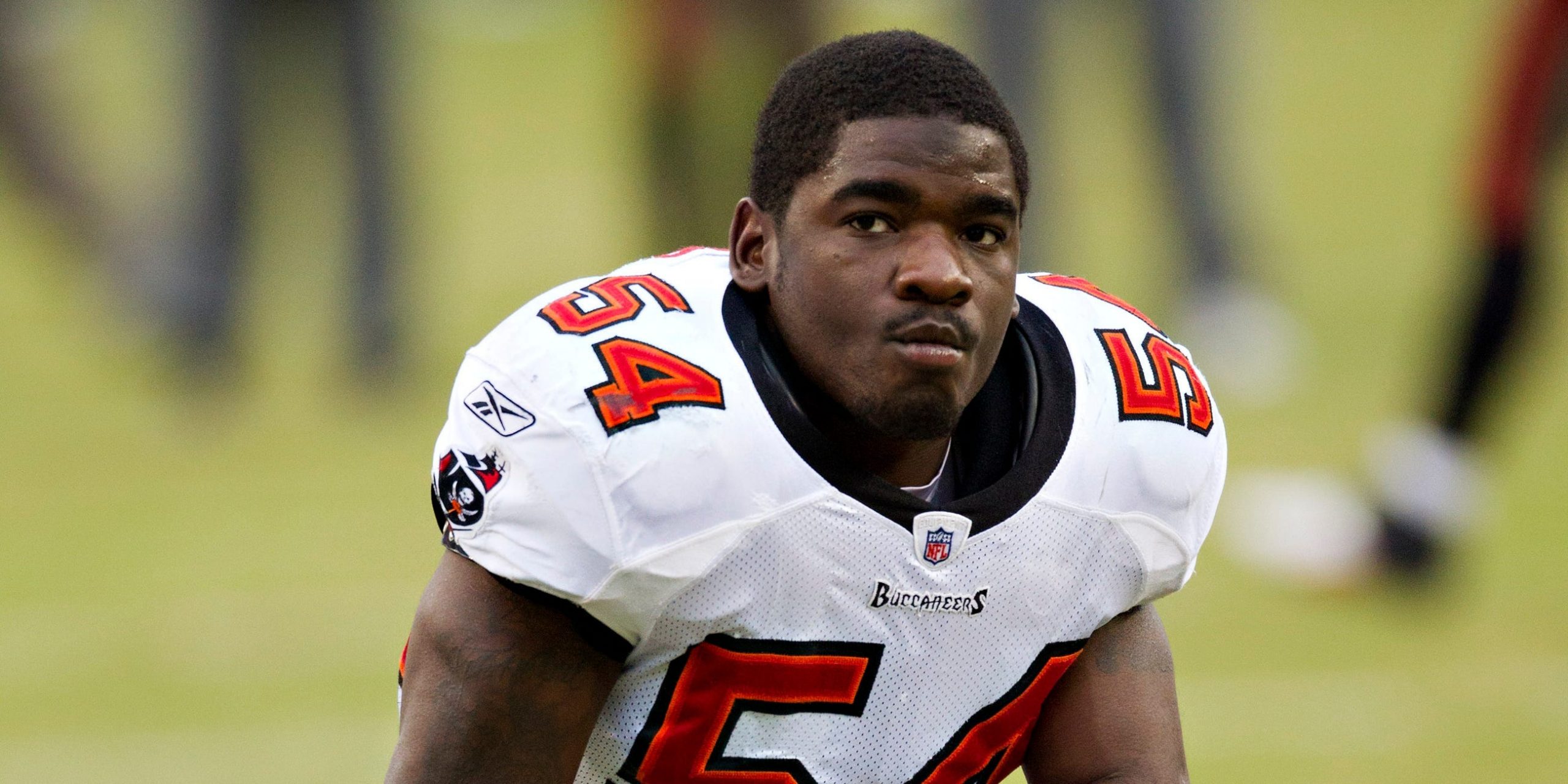 Geno Hayes #54 of the Tampa Bay Buccaneers watches the team warm up before a game against the Tennessee Titans at LP Field on November 27, 2011 in Nashville, Tennessee.
