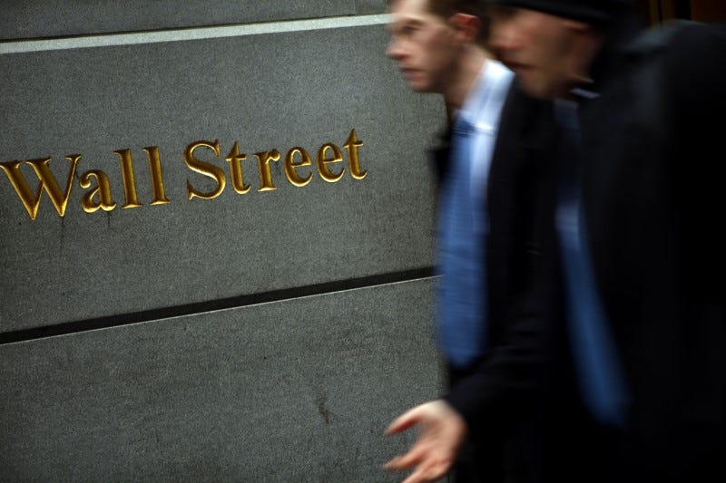 People walk past the New York Stock Exchange on Wall Street, February 10, 2009. REUTERS/Eric Thayer