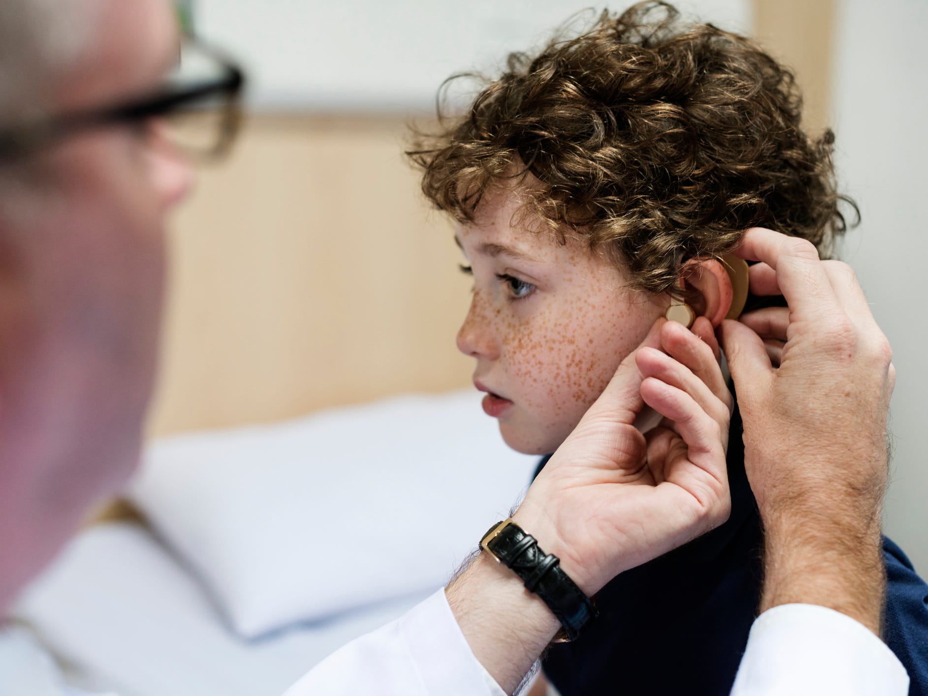 child being fitted for a hearing aid