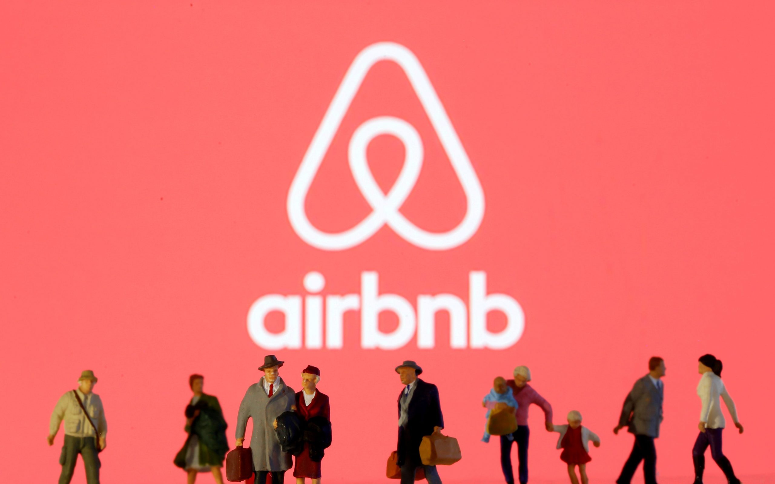 FILE PHOTO: Small toy figures are seen in front of diplayed Airbnb logo in this illustration taken March 19, 2020. REUTERS/Dado Ruvic