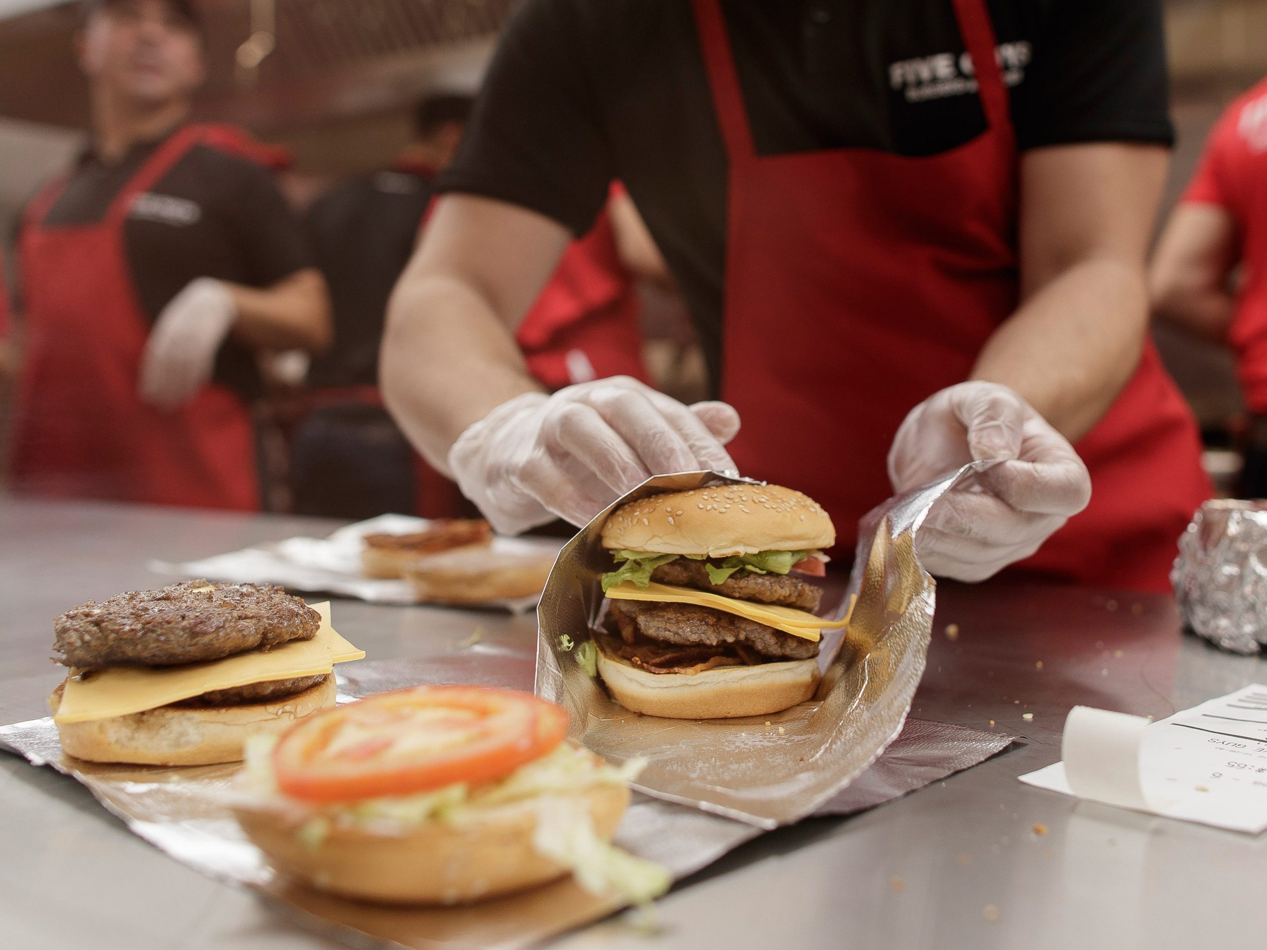 Workers prepare the products at the opening of the first restaurant 'Five Guys' in Spain in 2016.