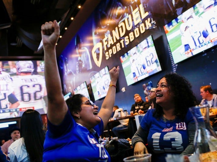 Silquia Patel, (R), 29, celebrates after making her bets at the FANDUEL sportsbook during the Super Bowl LIII in East Rutherford, New Jersey, U.S., February 3, 2019. REUTERS/Eduardo Munoz