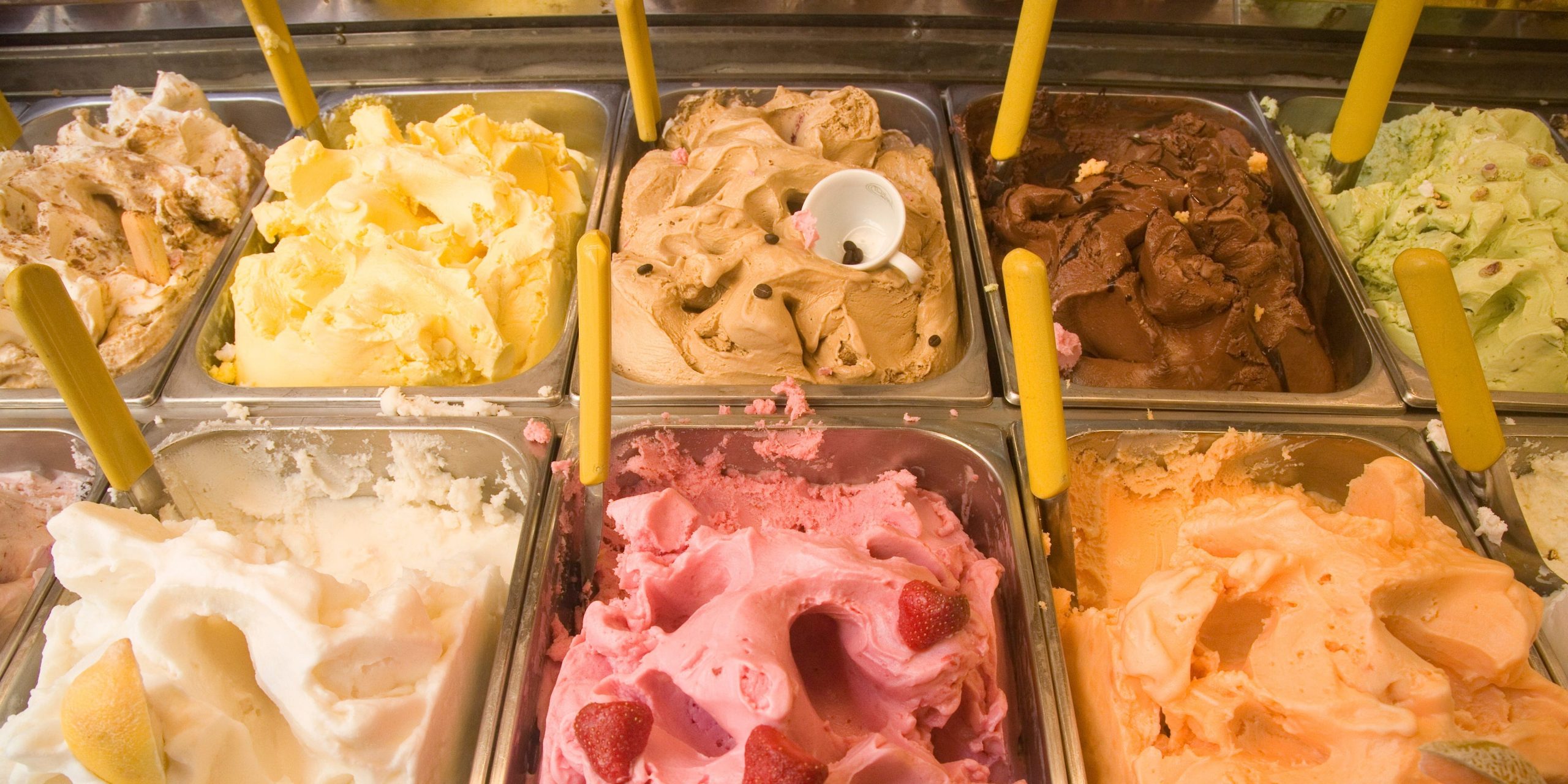 Rows of different gelato flavors in a chilled display.