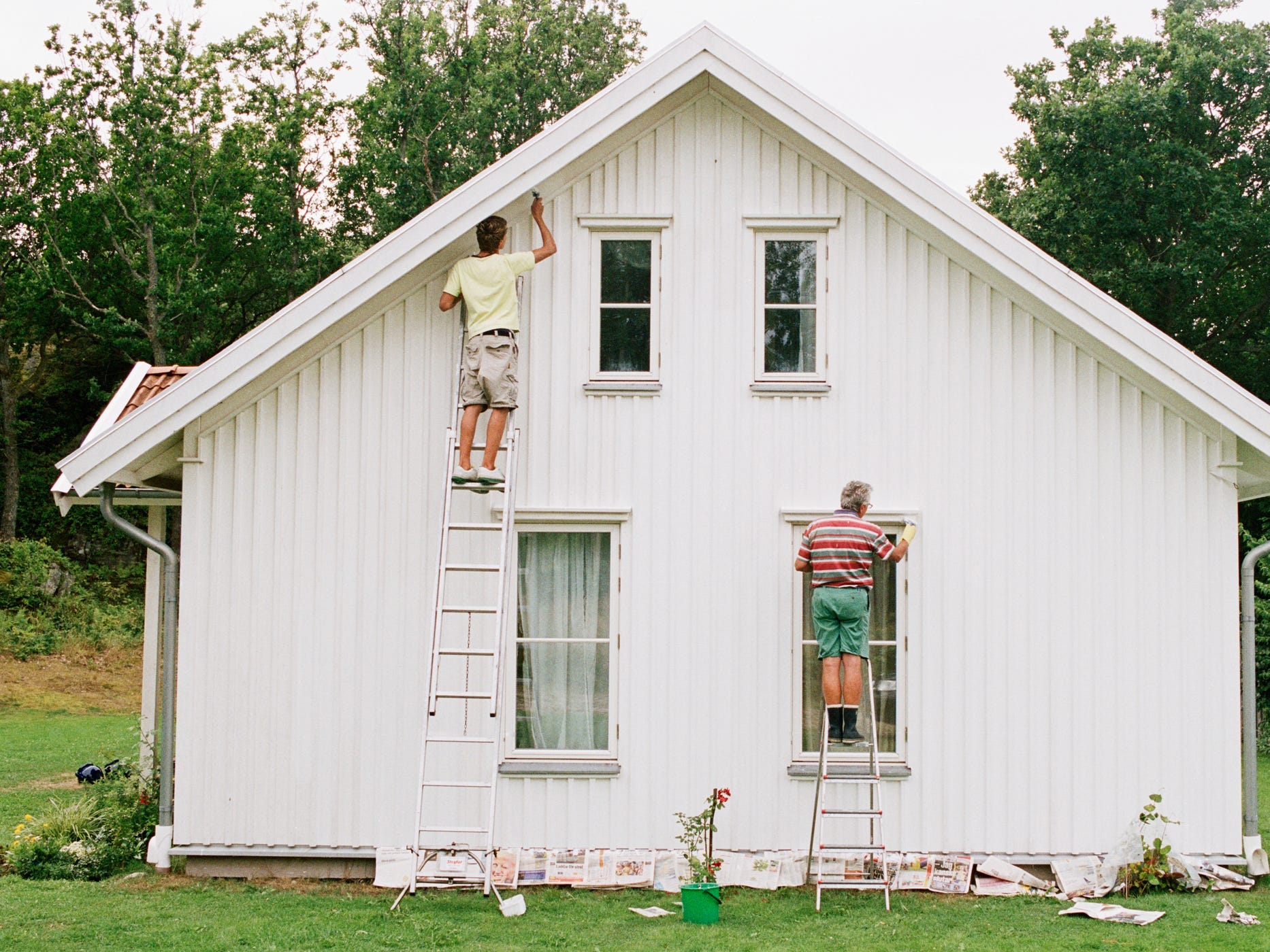 Men painting a house home repairs paint