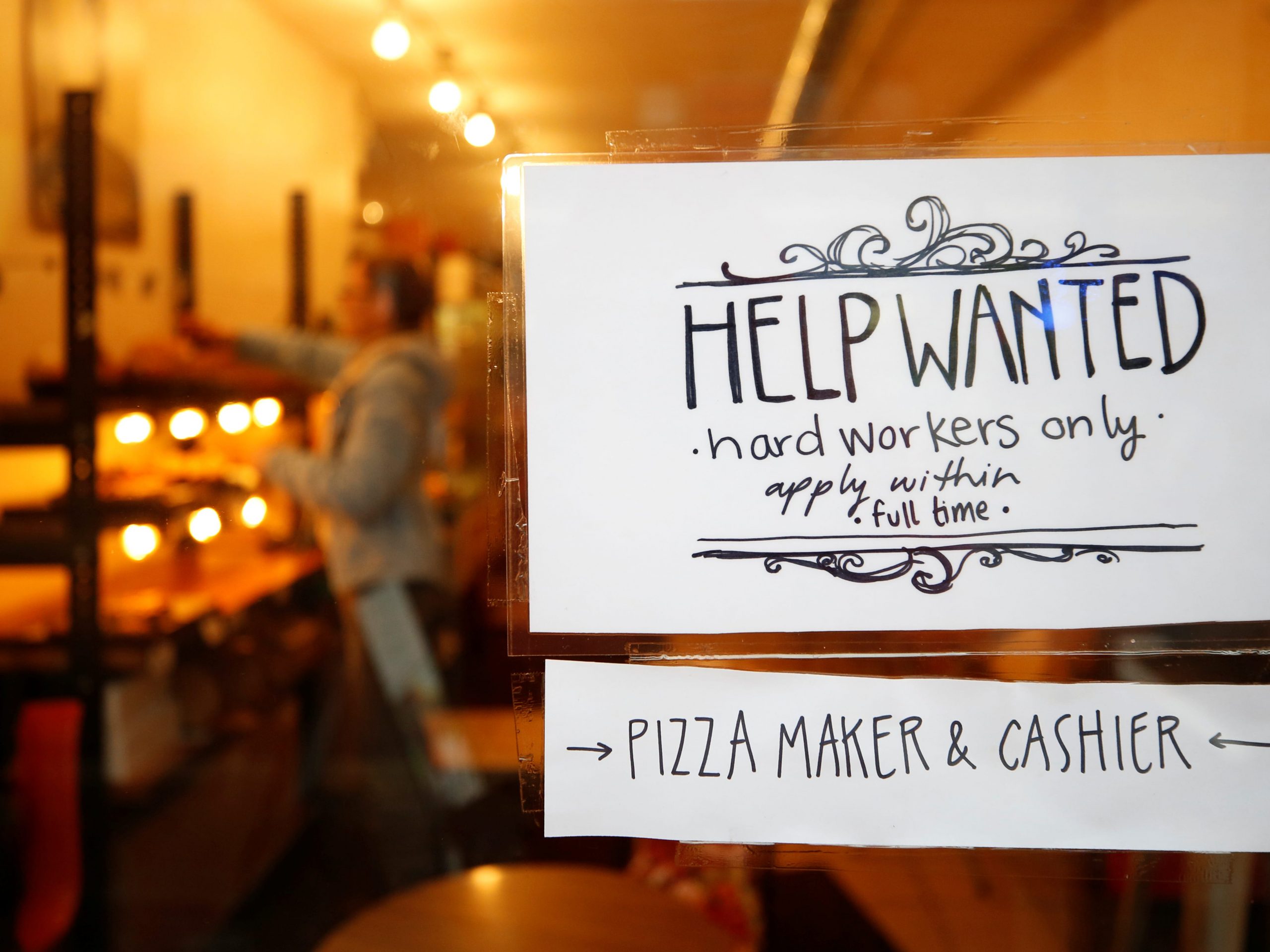 FILE PHOTO: A "Help wanted" sign is seen in the window of a bakery in Ottawa, Ontario, Canada, November 2, 2017. REUTERS/Chris Wattie